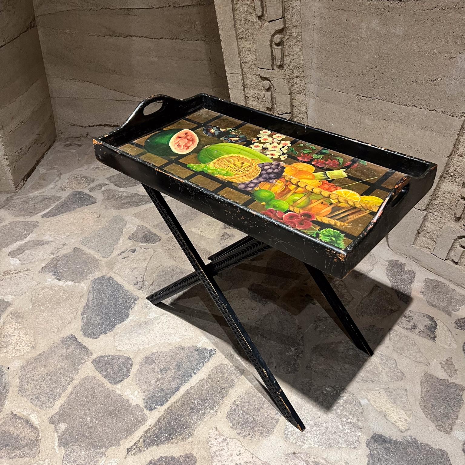 1960s Diseños Caaesa Folding Butler's Tray Table 
Hand Painted Gold Leaf on Wood
Still Life
Stamped by maker.
31 h x 18 d x 32
Folded 38 h x 8.75 d
Wood has decorative carvings painted black.
Original vintage unrestored patina. Wear is