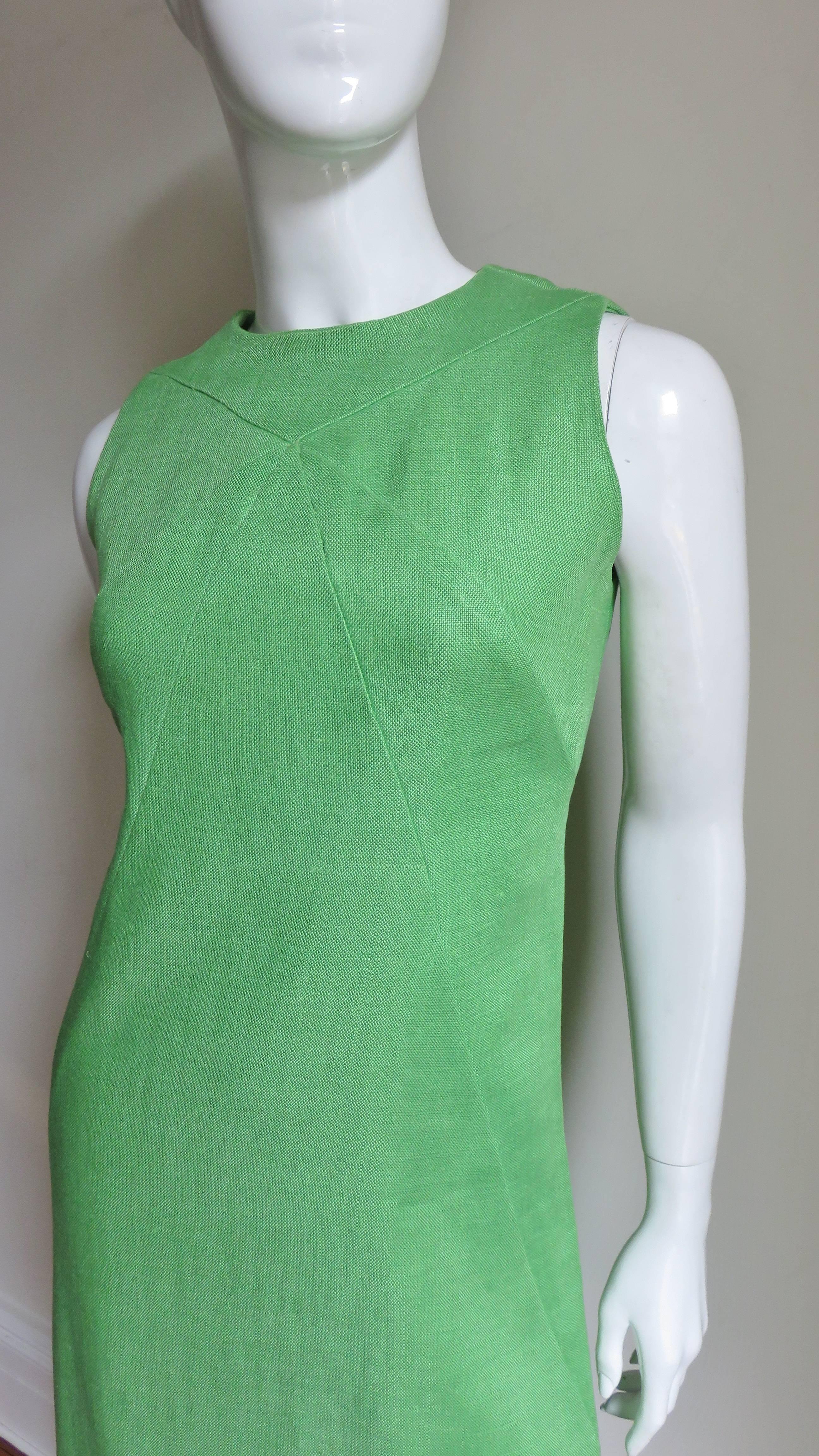 A fabulous green mid weight linen dress from the great American Designer Donald Brooks. It is sleeveless, skimming the body with a slight A line towards the hem. There triangular panels radiating from the center chest. Gorgeous dress!  It includes