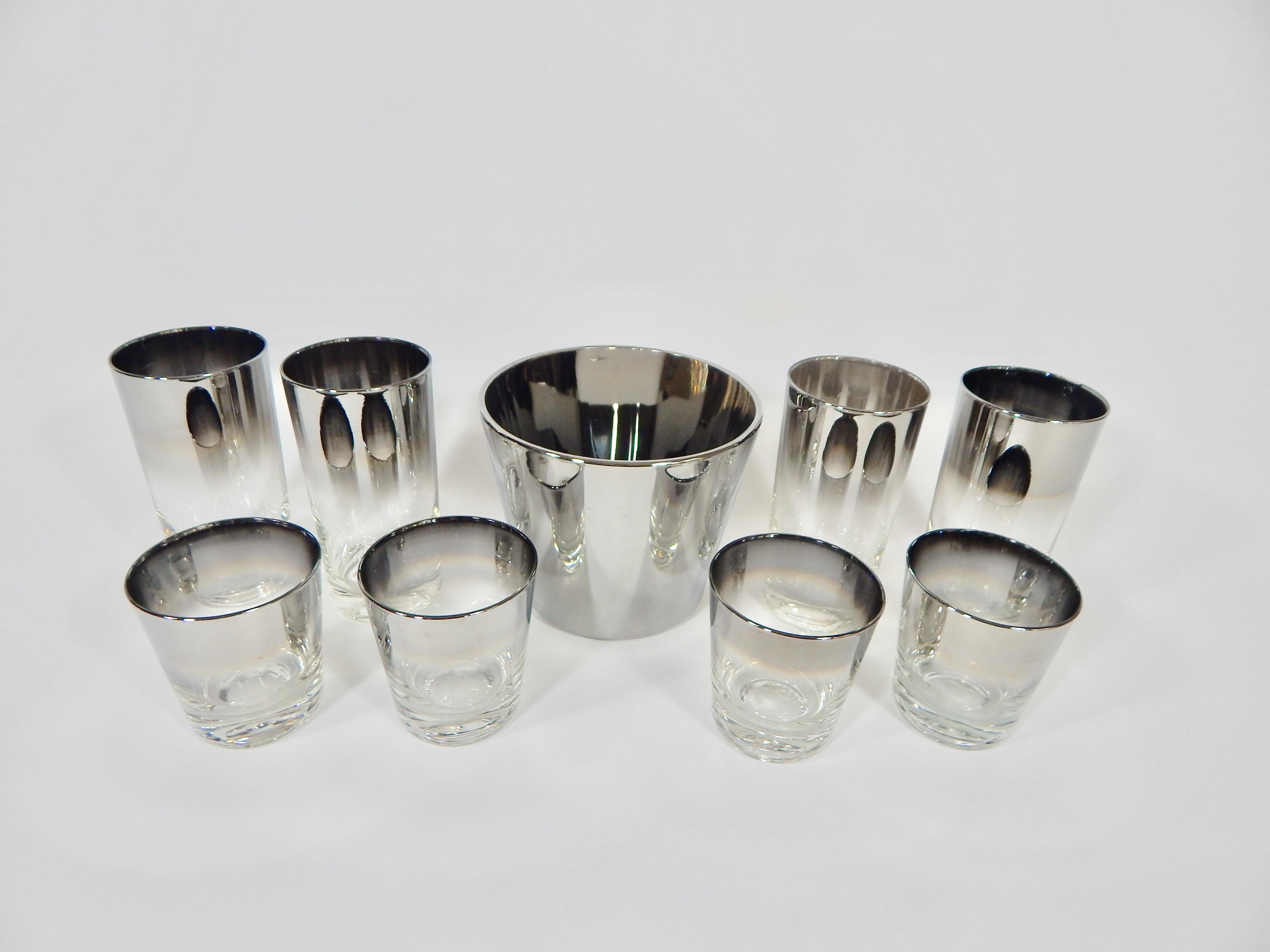 Midcentury Dorothy Thorpe set of 1960s silver glasses and ice bucket in the style.
Nine-piece set. Entire Set is in Excellent Condition. 
Measurements in inches:
Four highball glasses height 5.5, diameter 2.75
Four small tumblers height 3.25,