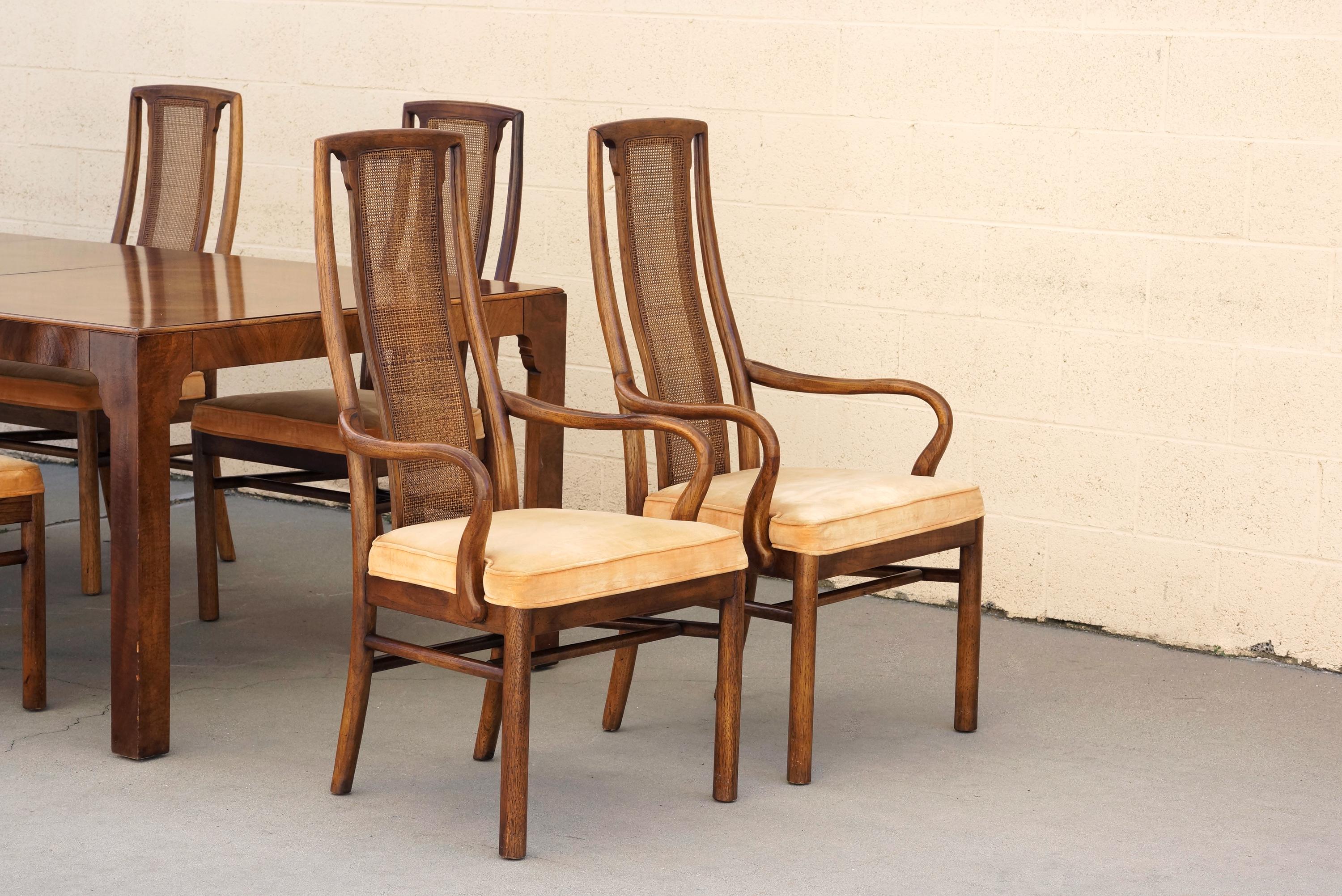 1960s Mid-Century Modern dining table with 8 chairs by Drexel Heritage. Gorgeous gloss walnut parquet table-top surface. Two-leaf design for extra length. High-back walnut chairs feature a modern curve with cane back. 

Stunning 11-piece set