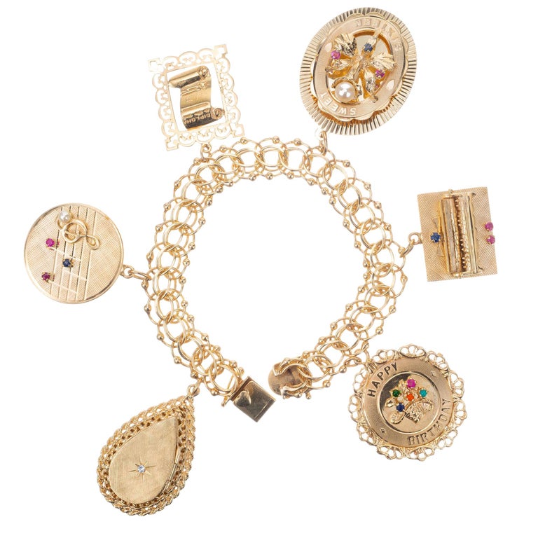 Traditional 1950s and 1960s Gold Charm Bracelet with Enamel and Mechanical  Charms