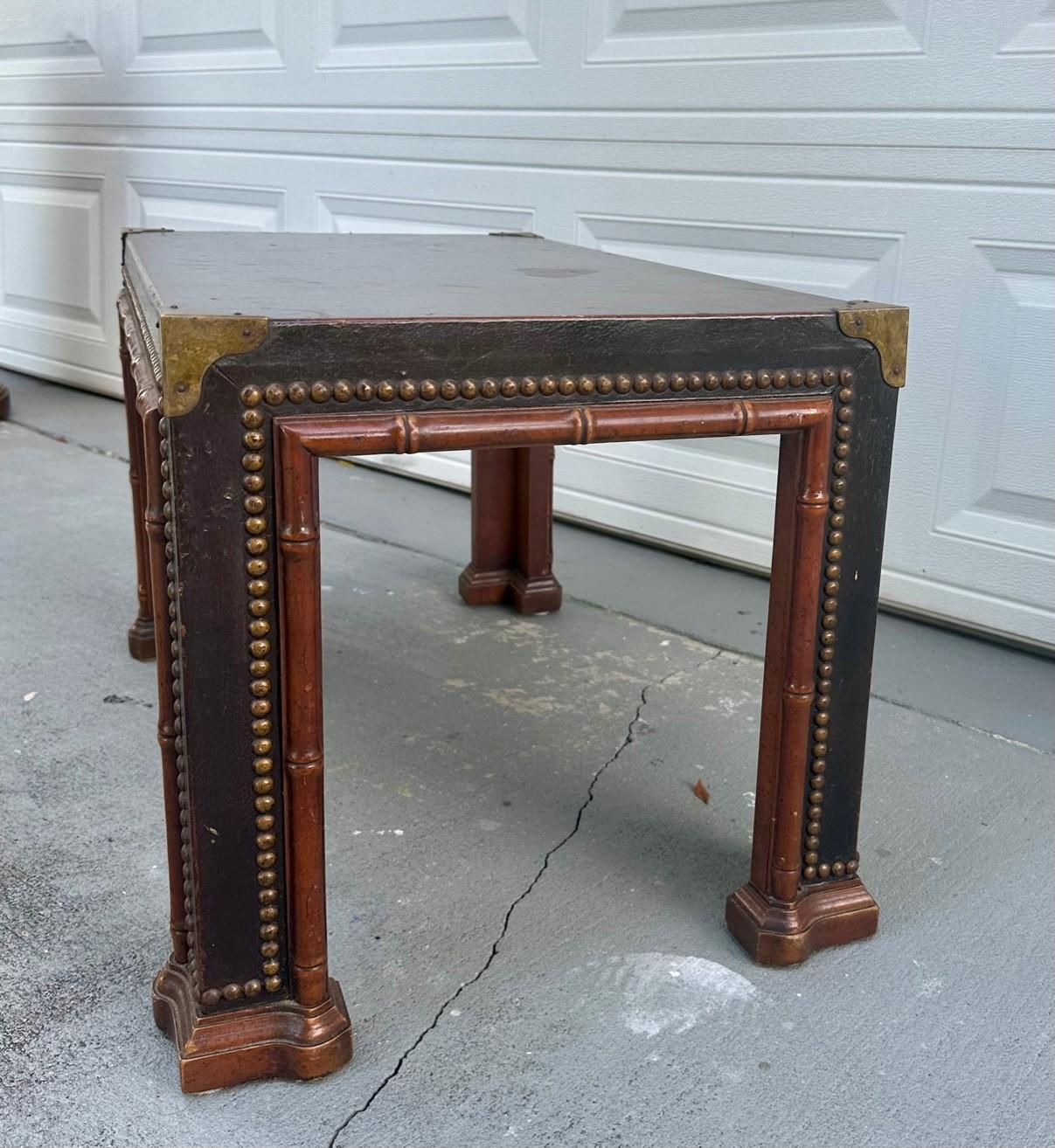 1960s Drexel ET Cetera Faux Bamboo Leather Wrapped Chinoiserie Coffee or Side Parsons Table

The vintage brown leather wrapped brass nail head studded side or coffee table was made in the 1960s. This quality leather covered parsons table in faux