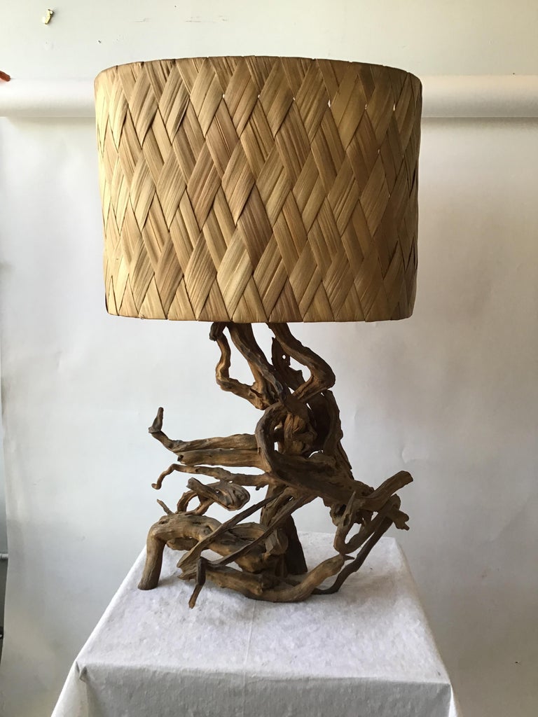1960s drift wood table lamp with wicker shade.