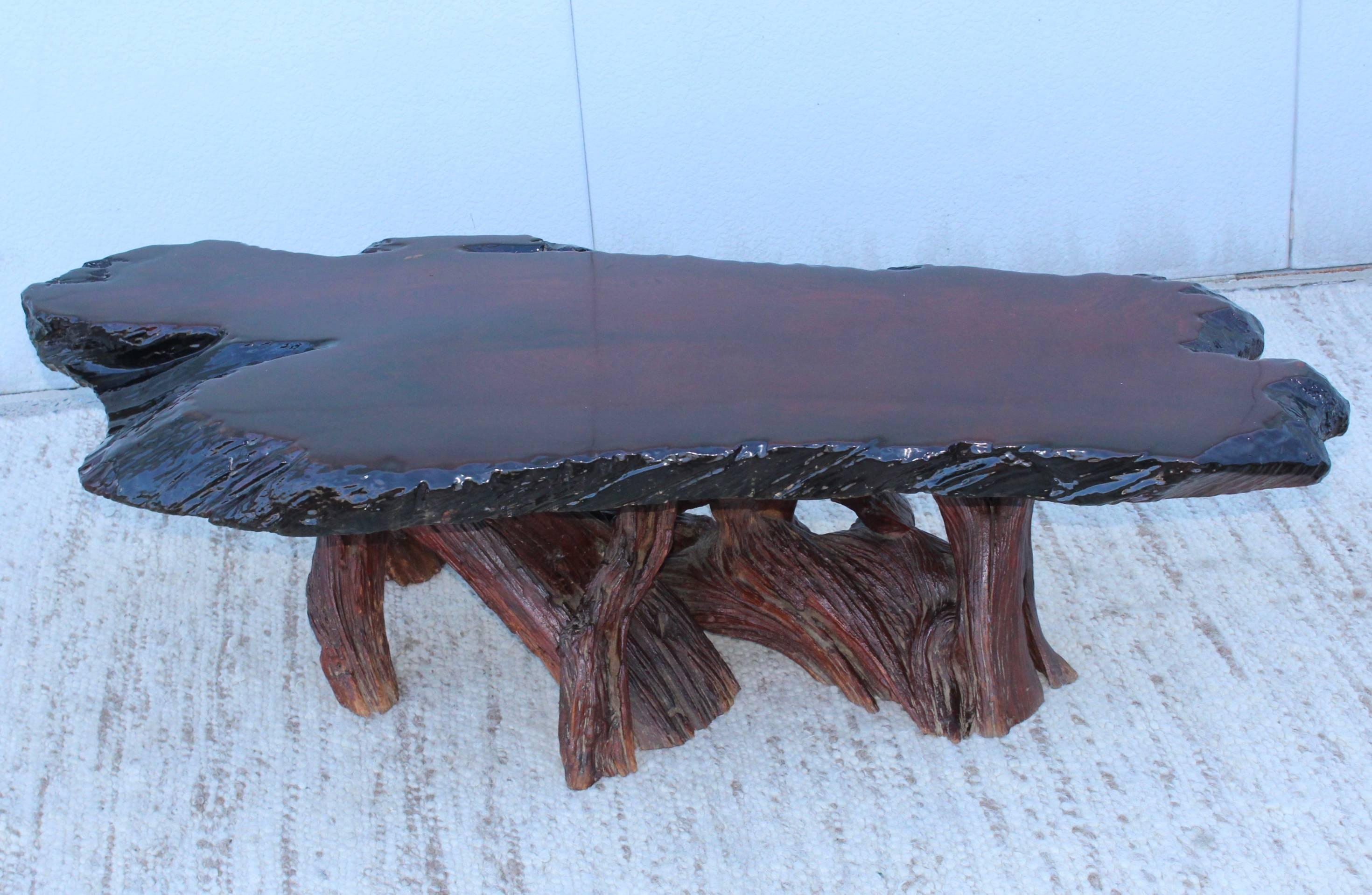 1960s modern driftwood coffee table with lacquered wood slab top, in vintage original condition.