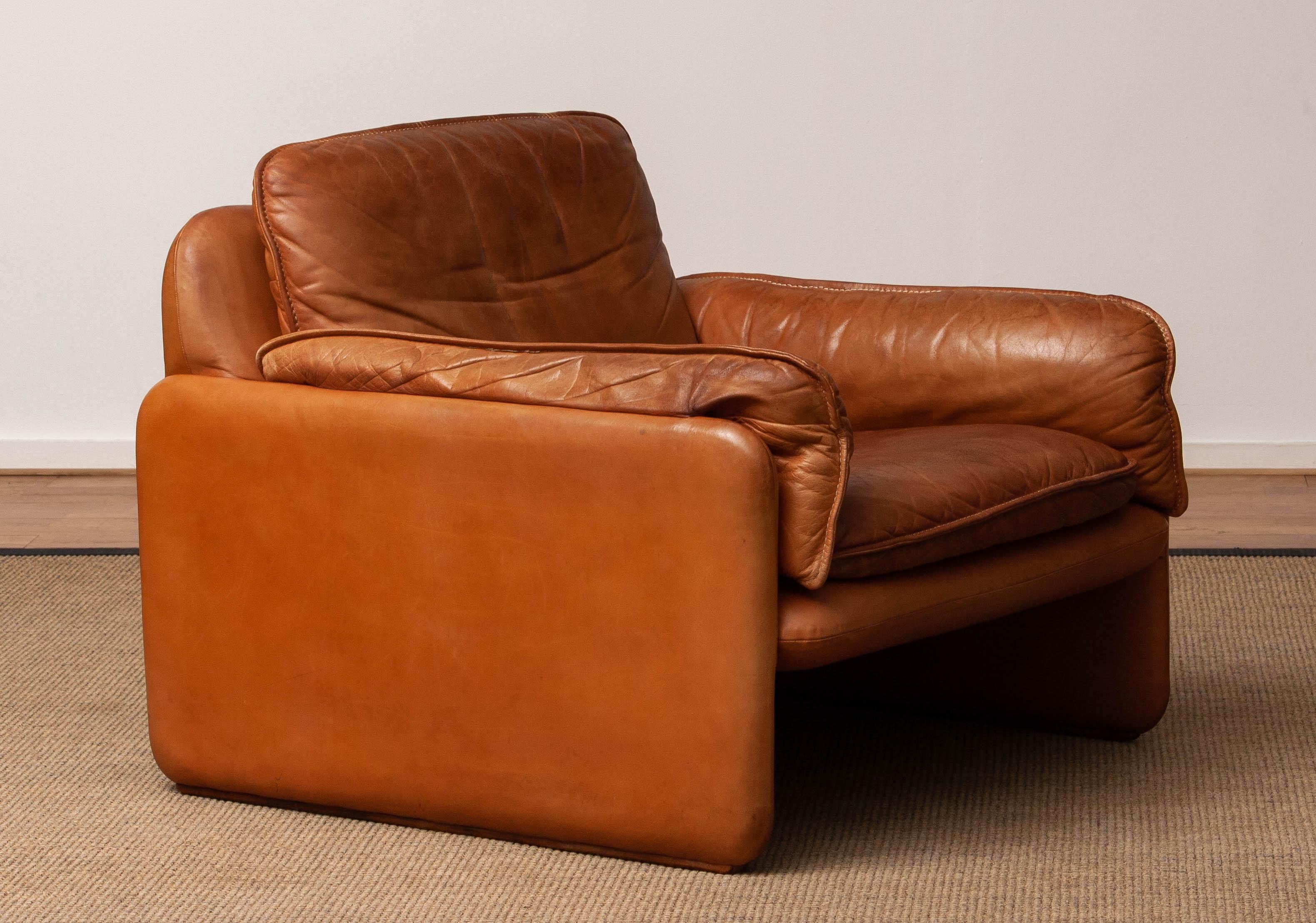 Beautiful DS-61 in cognac / nature color leather by 'De Sede' Switzerland from the 1960's with beautiful patina and in allover good condition. This lounge chair supports great and is an absolutely eye catcher in your interior.