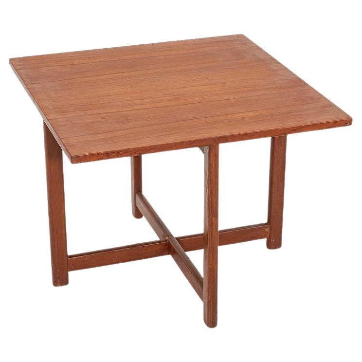 This is a Square Solid Teak end or side table, designed by Durup Polstermobelfabrik in Denmark in 1950. This piece dates to the 1960s. The table has crossed leg struts that offer ample support, and the wood has achieved a warm patina. There is a