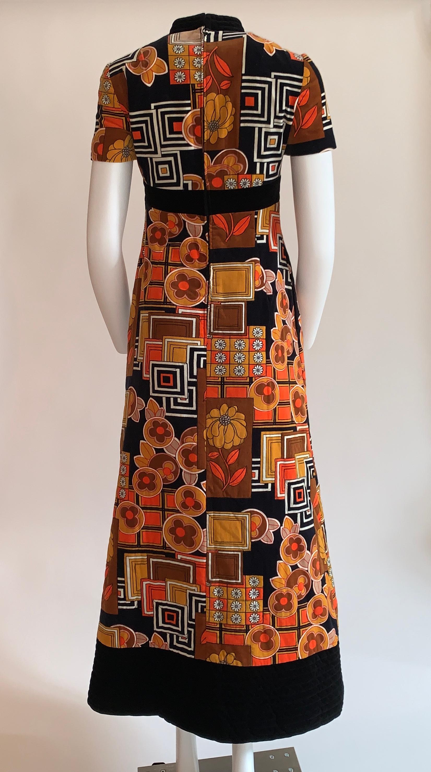 Vintage 1960s I. Magnin & Co. by Dynasty orange, brown and black floral print A-line quilted velvet maxi dress. Psychedelic floral and geometric pattern. Short sleeves and cheongsam inspired collar. Quilted band at waist. Back zip and hook and eye