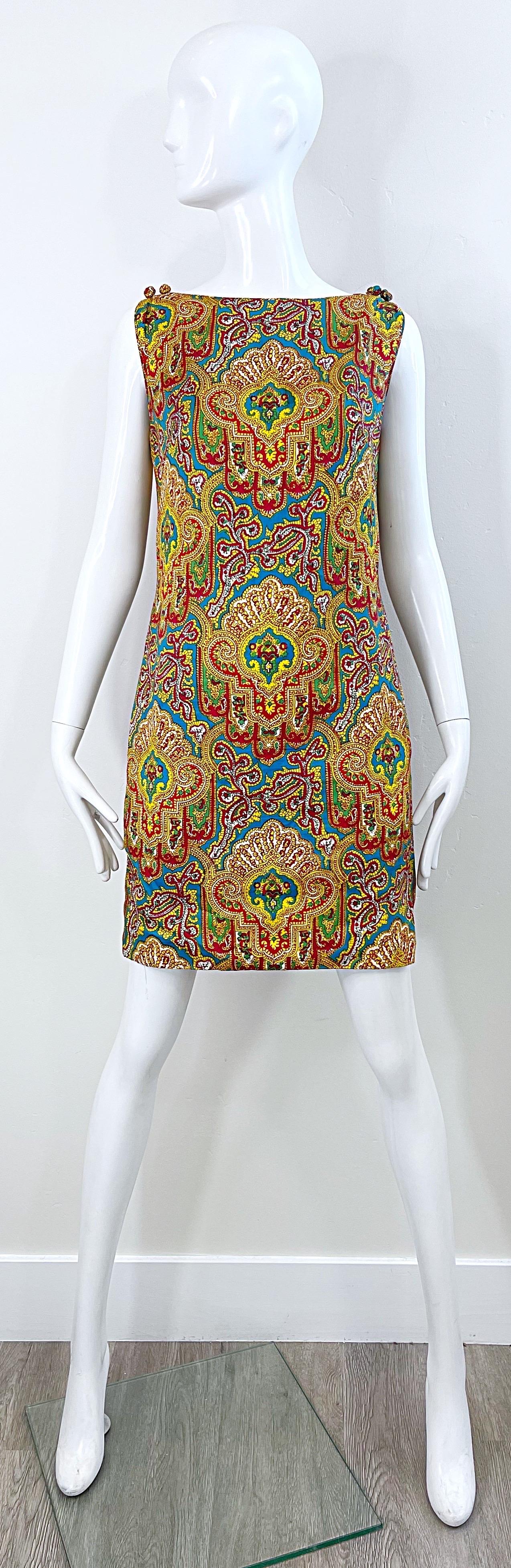 Chic 1960s DYNASTY paisley bright colorful silk sleeveless shift dress ! Features a tailored bodice, with hidden metal zipper up the back and hook-and-eye closure. POCKETS at each side of the hips. Two fabric covered mock buttons at each shoulder.