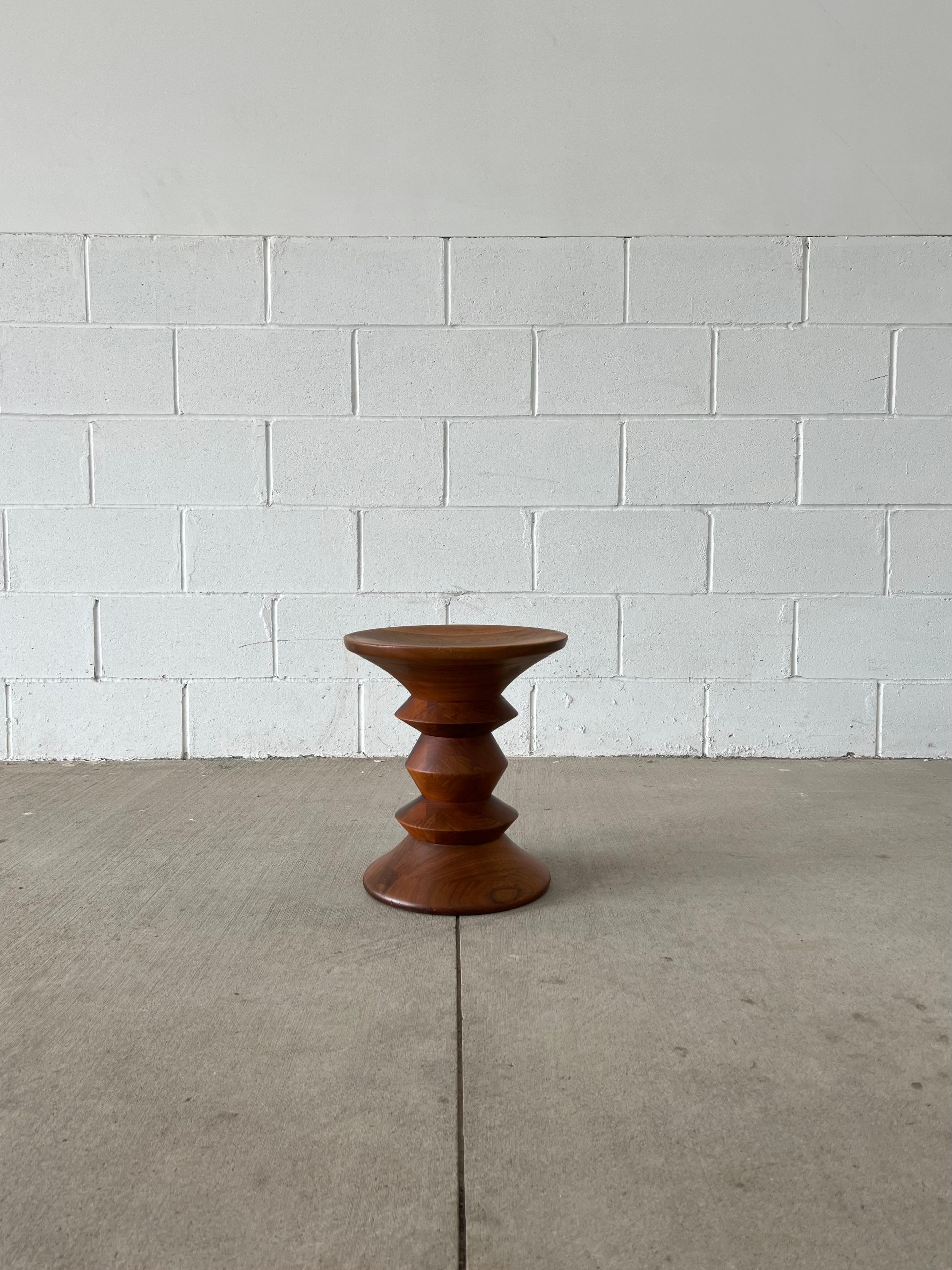 Originally designed for the Time Life Building in New York City, the Eames stool model C is one of 3 stool variants that were designed for the building's interiors. Made of solid walnut, the stool is turned and sculpted until its balanced form is