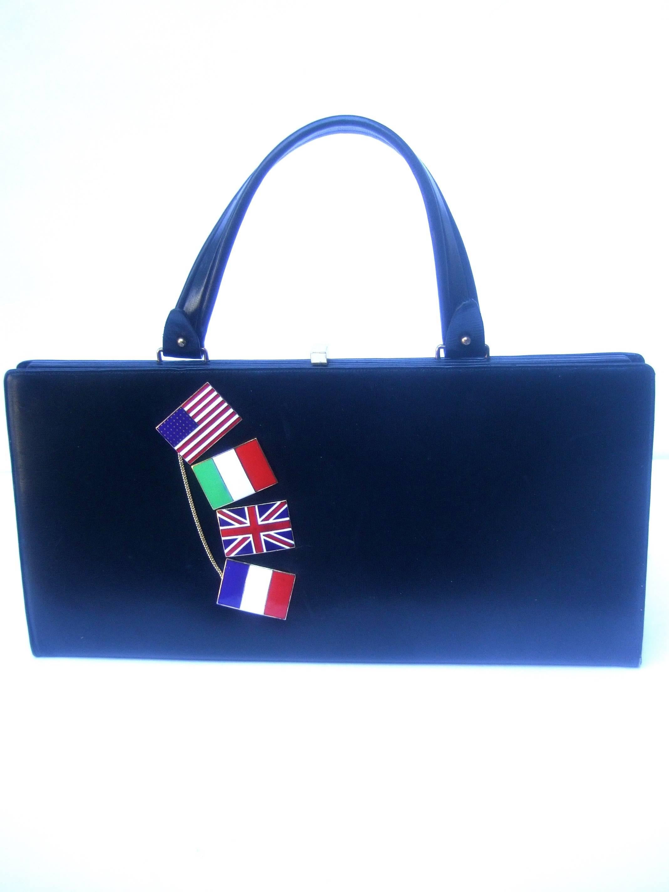 1960s Ebony leather cloisonné enamel flag theme handbag 
The stylish retro handbag is adorned with four enamel flags
The collection of flags represent the US, Italy, Great Britain 
and France 

The collection of cloisonné enamel flags are accented