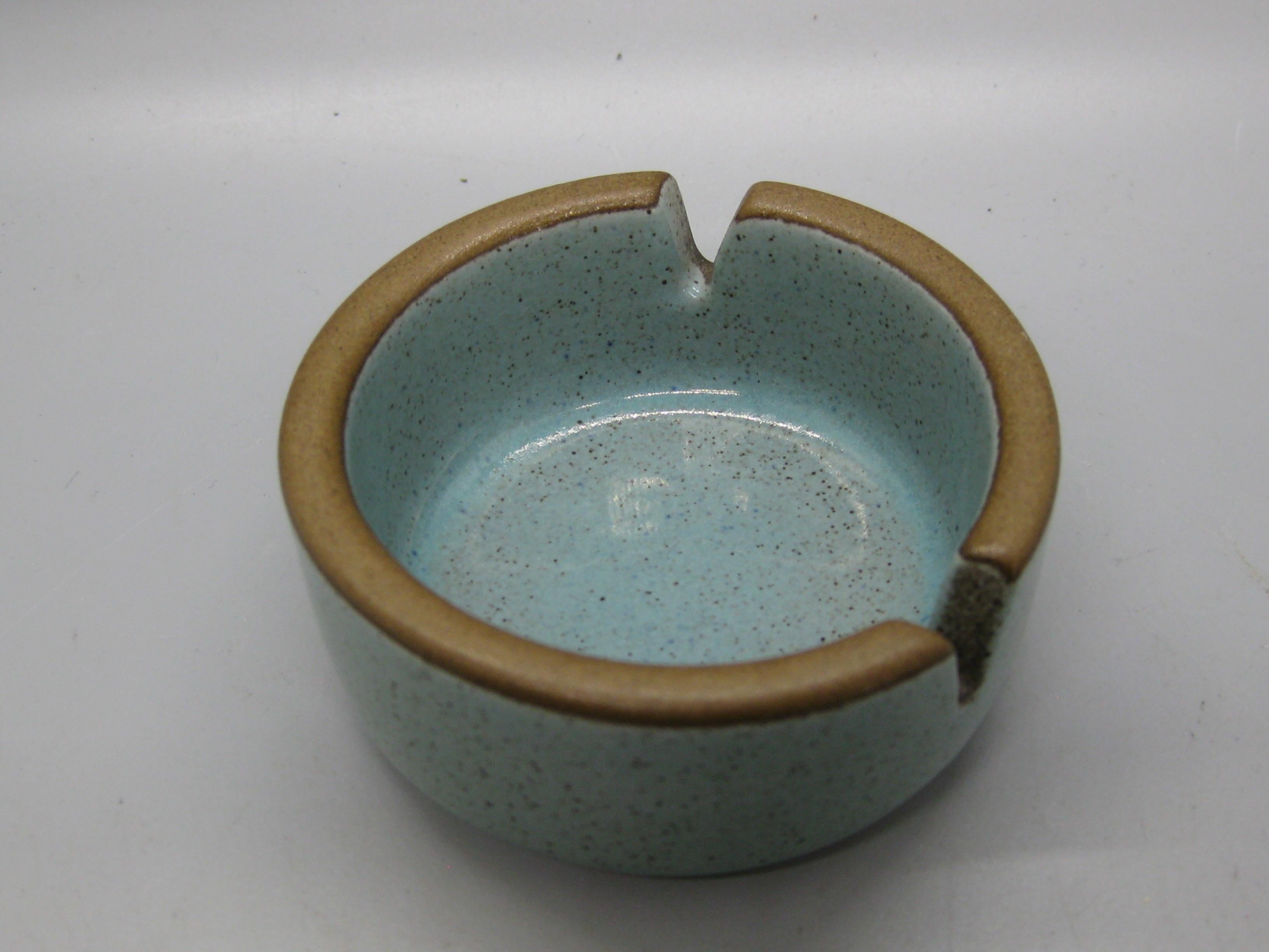 Wonderful Edith Heath ceramic turquoise ashtray. The California pottery piece has a wonderful turquoise color and two places for cigarettes. Signed on the bottom. In excellent shape and appears it has never been used. No chips, no nicks and no