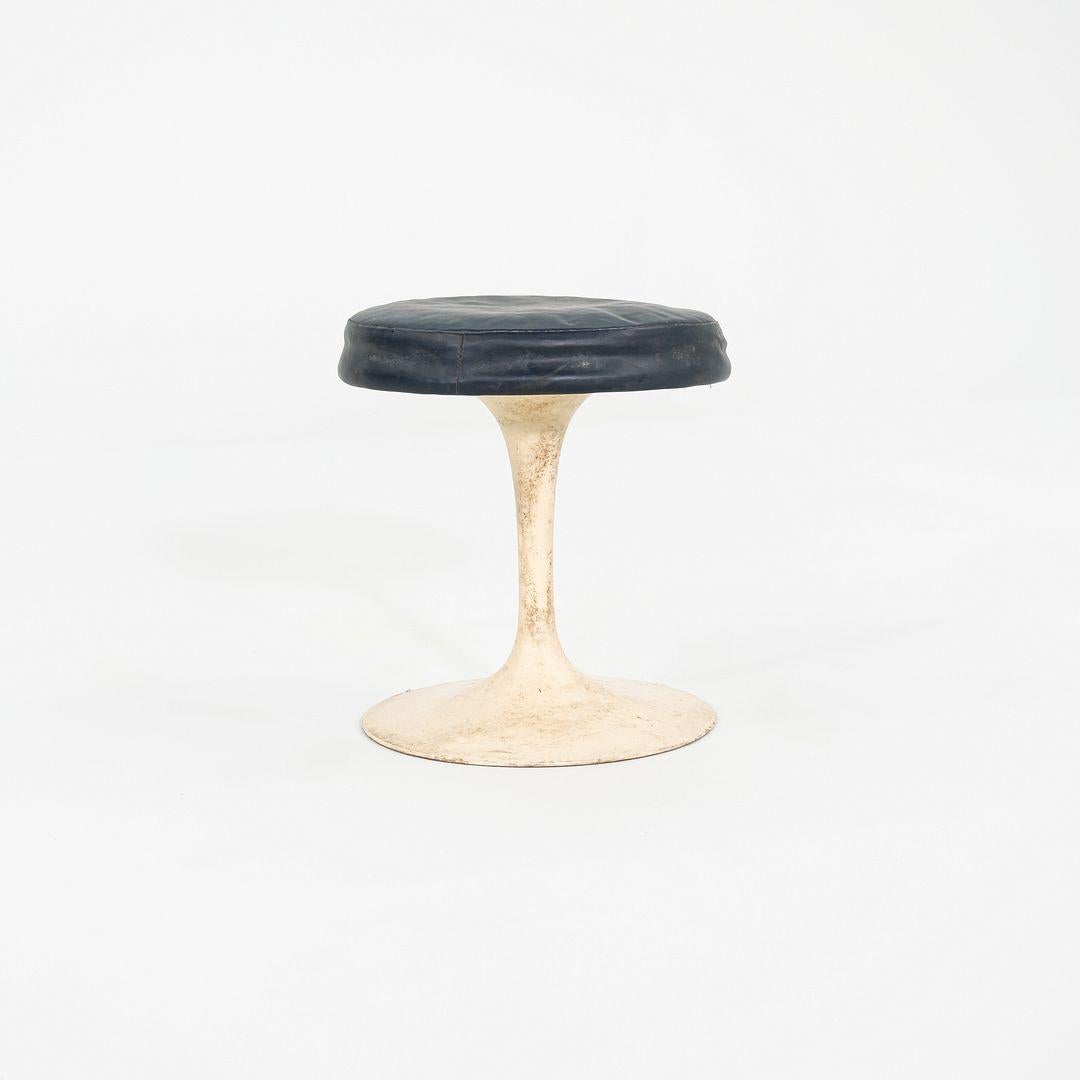 These are 152 Tulip Stools, originally designed by Eero Saarinen in 1956. These particular examples were produced by Knoll in the USA in the 1960s. The stools are comprised of vinyl upholstered seats atop aluminum bases. They appear to swivel,