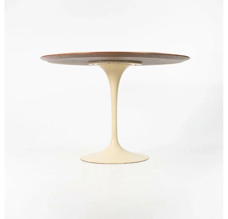 Listed for sale is a 1960s vintage tulip dining table, designed by Eero Saarinen and produced by Knoll. This is a gorgeous vintage example, which retains its original cast iron base (the early versions are exceptionally heavy). The top was just