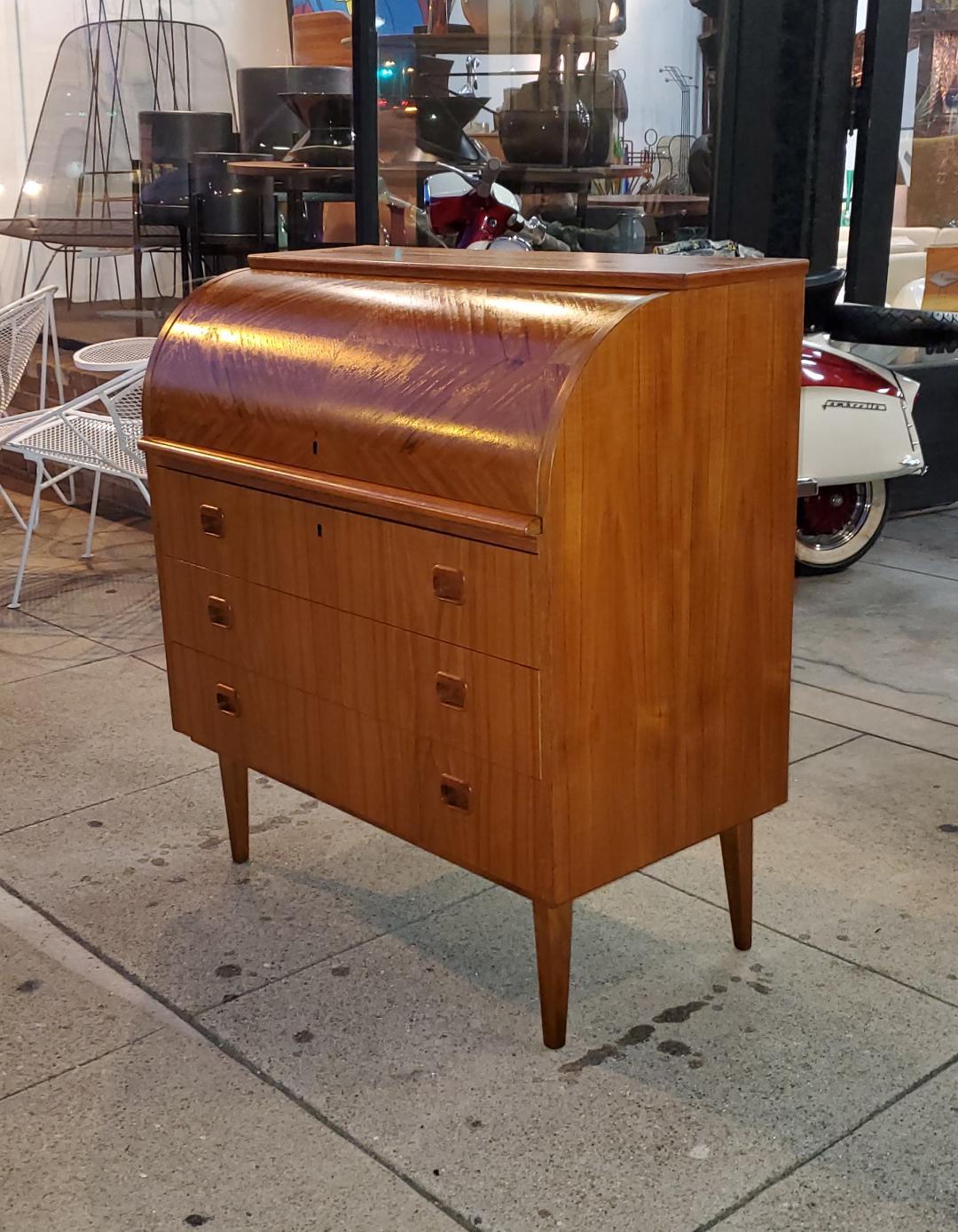 Vintage 1960s Teak Scandinavian Modern Roll Top Desk Designed by Egon Ostergaard For Svensk Mobelindustri, Made In Sweden. Also Known As A Swedish Secretaire.

Beautiful Teak Wood Grain Design On The Roll Top Itself, With Three Spacious Pull Out