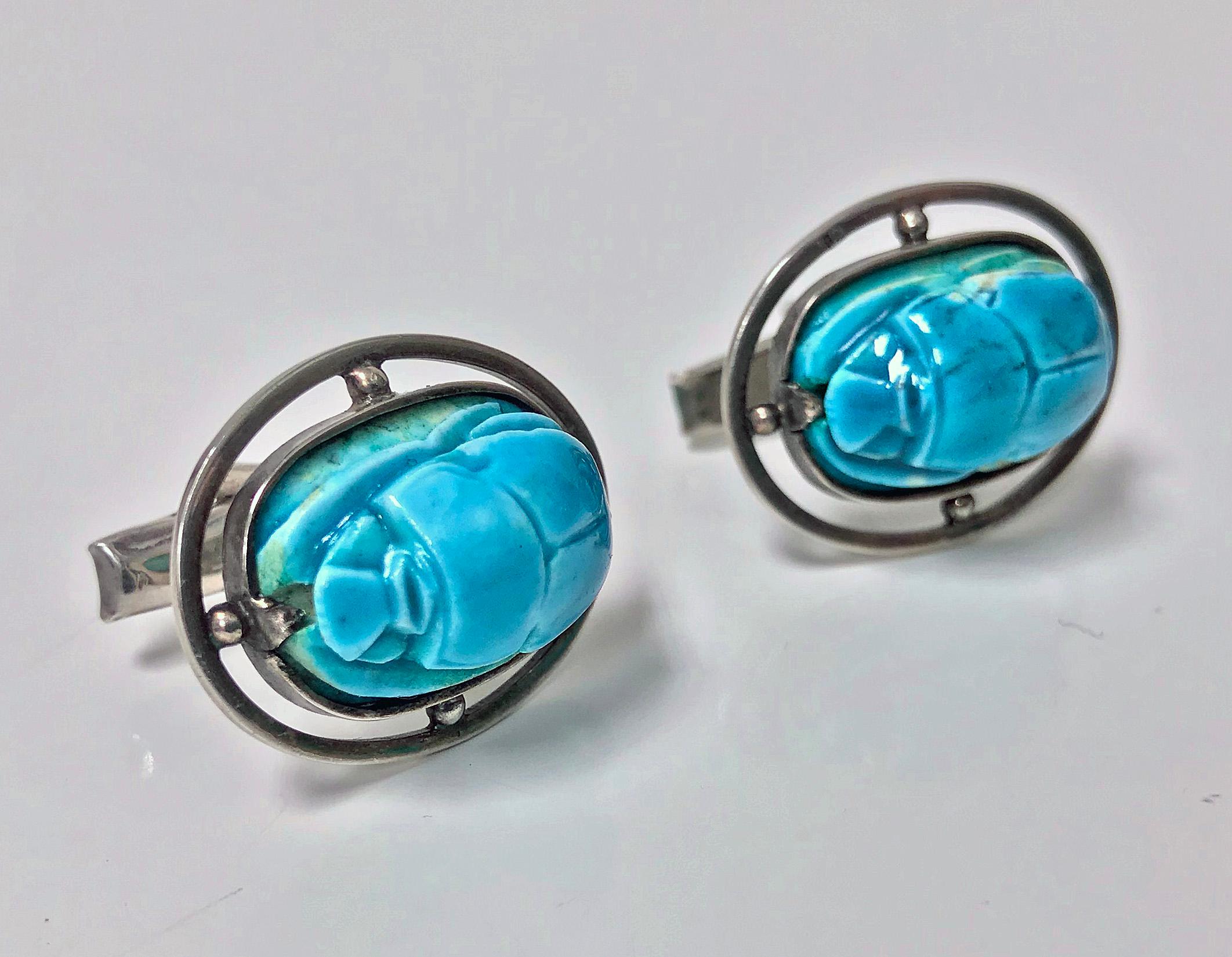 Pair of vintage Egyptian revival Silver turquoise scarab beetle cufflinks, C.1960. Split  silver bezel set and bead edge mounts with a turquoise faience scarab. Silver mounts and fitments stamped with Egyptian silver hallmarks. Hinged T bar