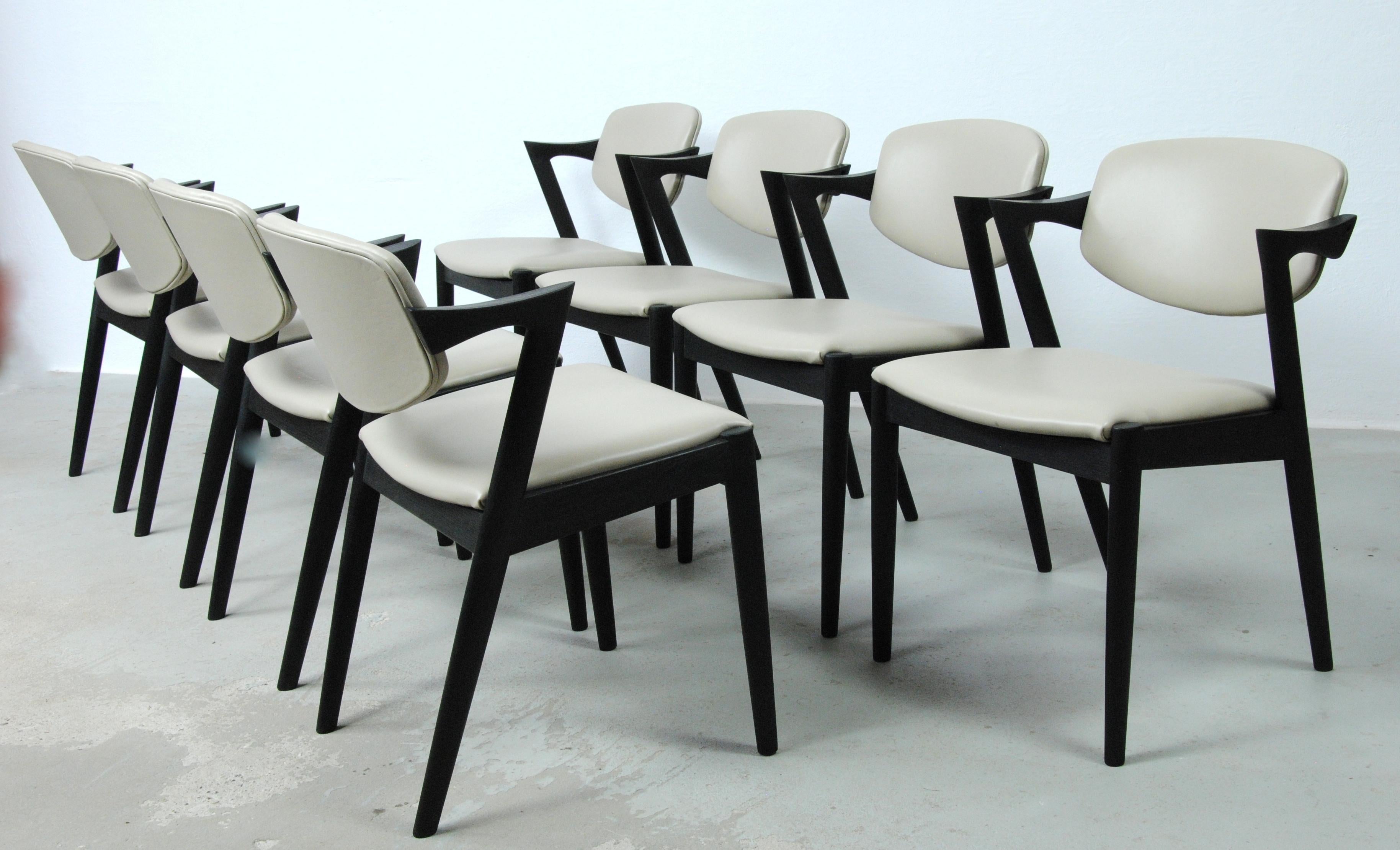 Set of 8 fully restored and ebonized model 42 oak dining chairs with swivel backrests by Kai Kristiansen for Schous Møbelfabrik., 

The chairs have Kai Kristiansen’s typical light and elegant design that make them fit in easily where you want them