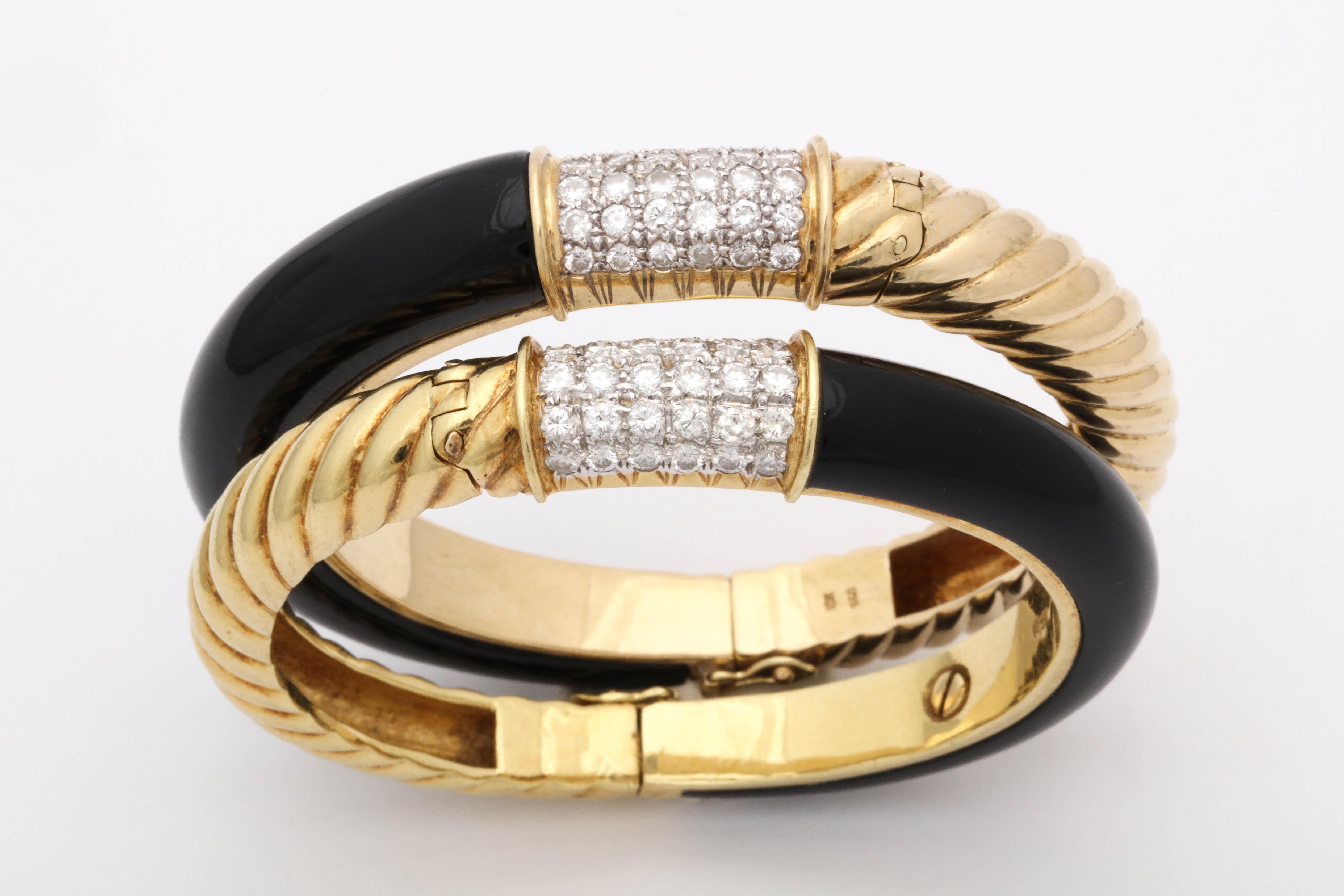 One Pair Of ladies 18kt High Polish Textured Ridged Gold Pair Of Bangles. Bangles Are Designed With Custom Cut Shiny PBlack Onyes On One Side And Designed With Ridged gold Pattern Design On The Other Side. Embellished with Two Diamond Center Rows
