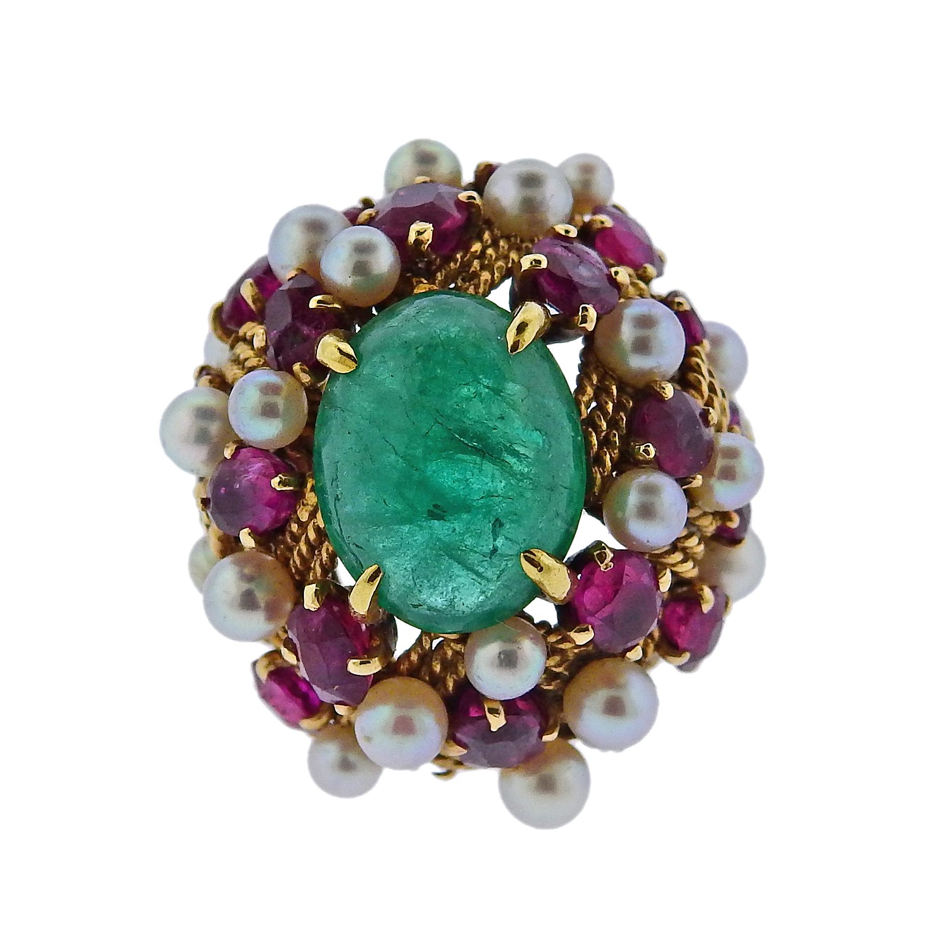 Circa 1960s 18k gold cocktail ring, set with 12.5mm x 9.9mm emerald cabochon in the center, surrounded with rubies and pearls. Ring size - 4.5, ring top - 25mm x 23mm. Weight is 13.6 grams.