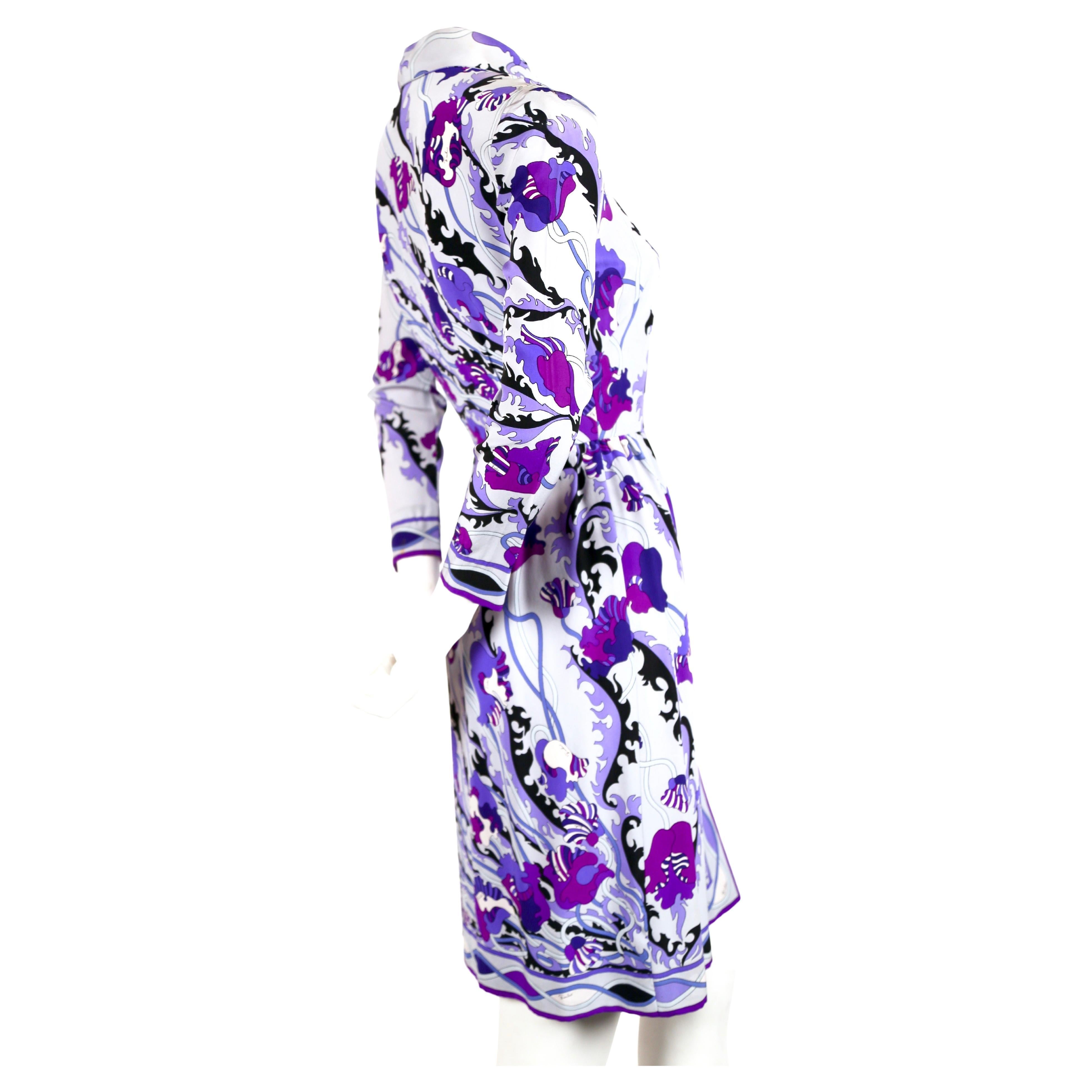 Vibrant, floral printed silk dress by Emilio Pucci dating to the 1960's. Beautiful color scheme in tones of blue, purple with black accents. Snap closure at front. Fits a US 2. Bust measures approximately 34