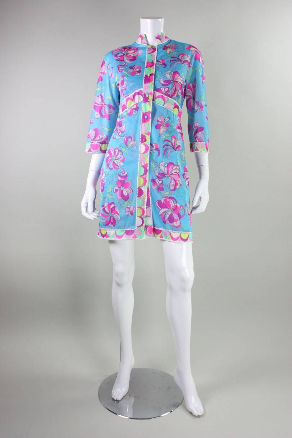 Vintage robe and nightgown/slip set by Emilio Pucci for Formfit Rogers dates to the 1960's through early 1970's.  It is made of aqua blue nylon that features a bold and bright floral pattern.  Robe has mandarin collar and center front covered button