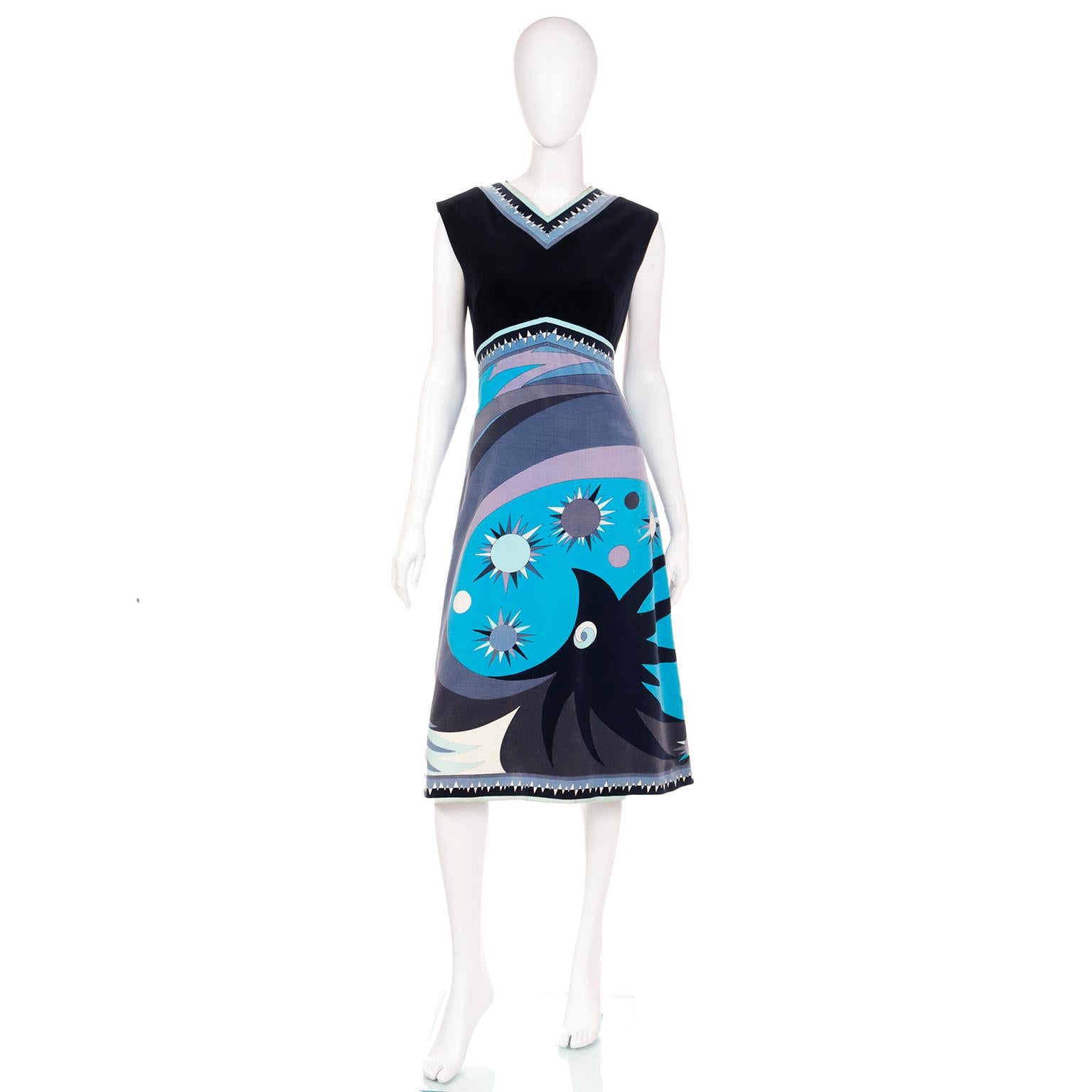 This outstanding 1960's vintage Emilio Pucci dress is in a smooth cotton velvet and features a rare bold abstract signature print in shades of blue, purple, pink and black. The signature print creates the lower portion and the bodice is black velvet