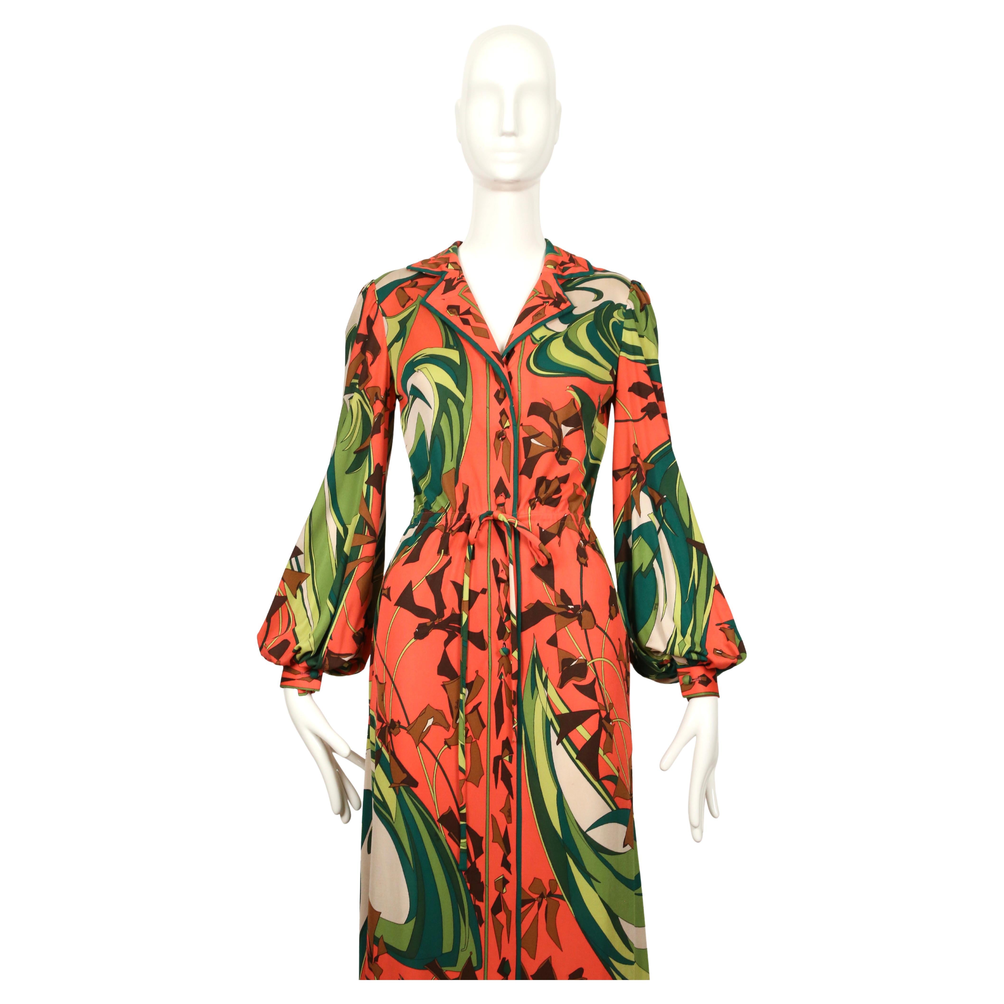 Exceptional, vivid, printed silk jersey dress from Emilio Pucci dating to the 1960’s. Dress features a slim fit with billowing sleeves, button front closure and a cinched drawstring waistline. Pucci signatures throughout. Dress is labeled a US size