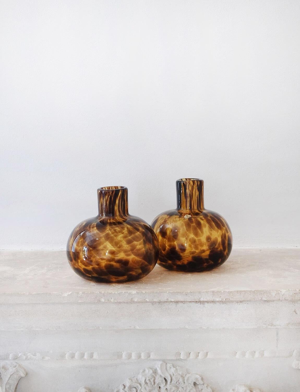 A beautiful pair of hand-blown Empoli glass Tortoiseshell ornamental bottles made in the 1960s. Both bottles have their original Empoli glass sticker intact. Empoli in Tuscany was a renowned glass making centre in Italy and is famous for this type
