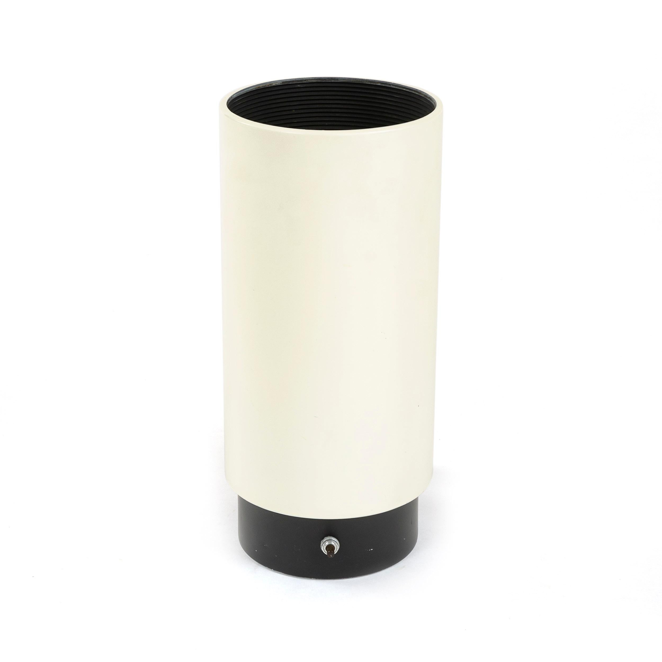 A cylindrical off-white enameled floor / desk uplight by Lightolier.