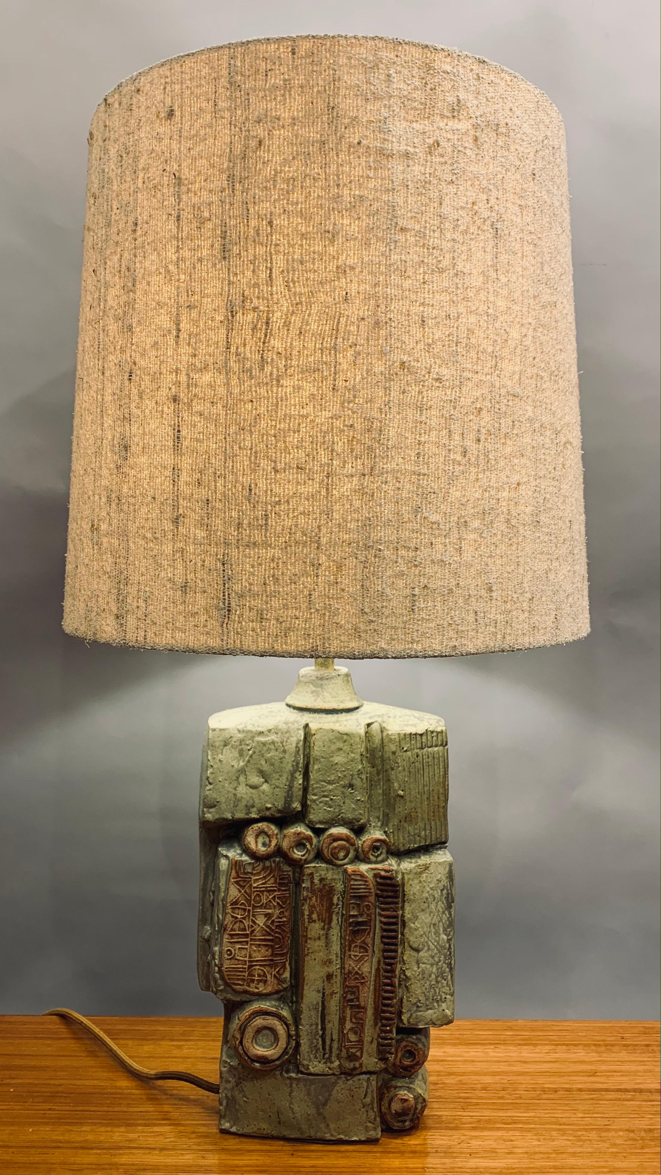An unusual abstract ceramic table lamp designed by Bernard Rooke in England during the 1960s.  This abstract and sculptural handmade piece in natural terracotta stone combined with both unglazed and glazed contrasting finishes. In excellent vintage