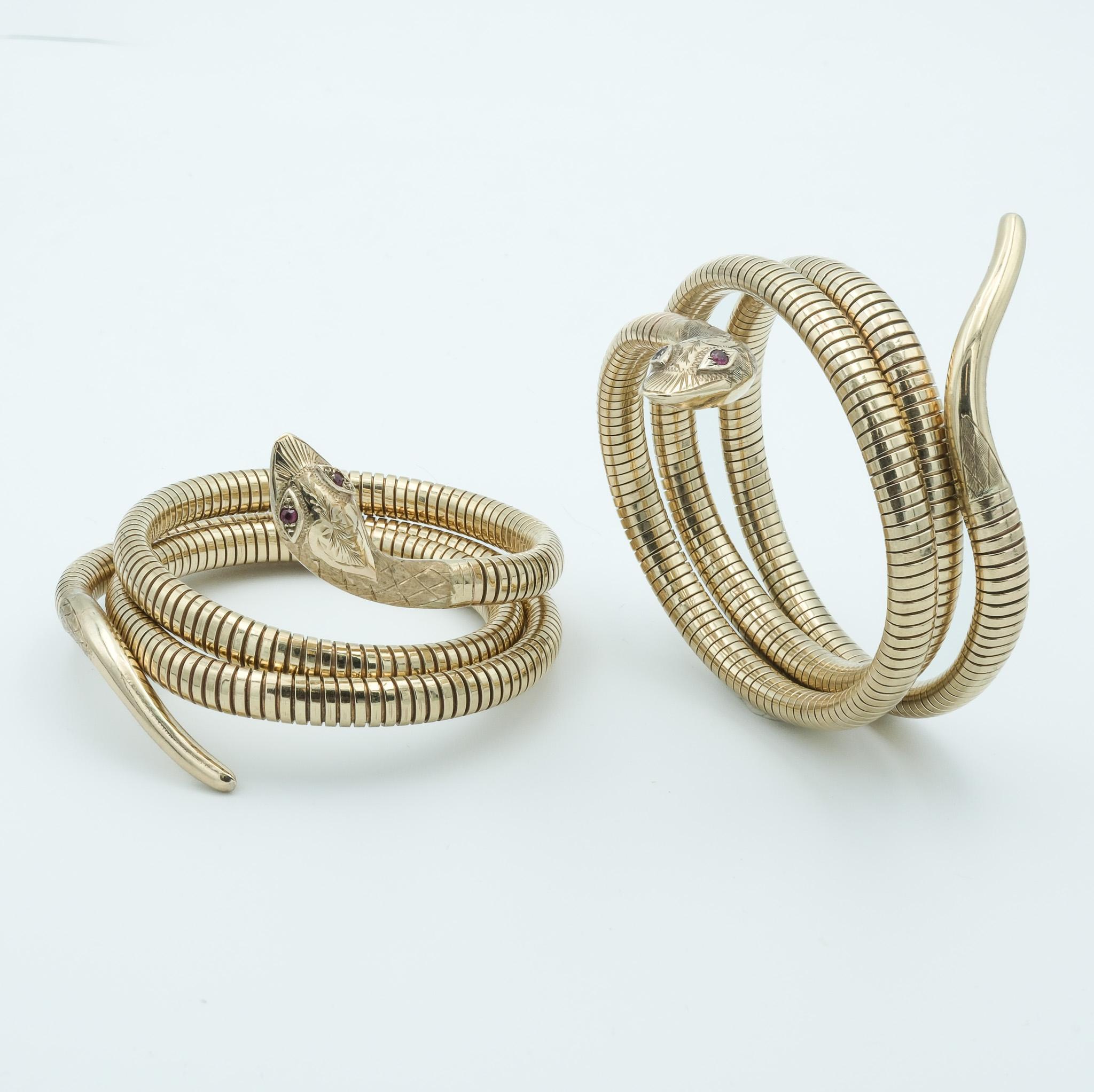 These are two exquisite 1960s English Birks 9k rose gold snake bracelets, each meticulously crafted to resemble the sinuous form of a serpent. The design captures the essence of the 1960s fascination with bold and elegant motifs. Both bracelets have