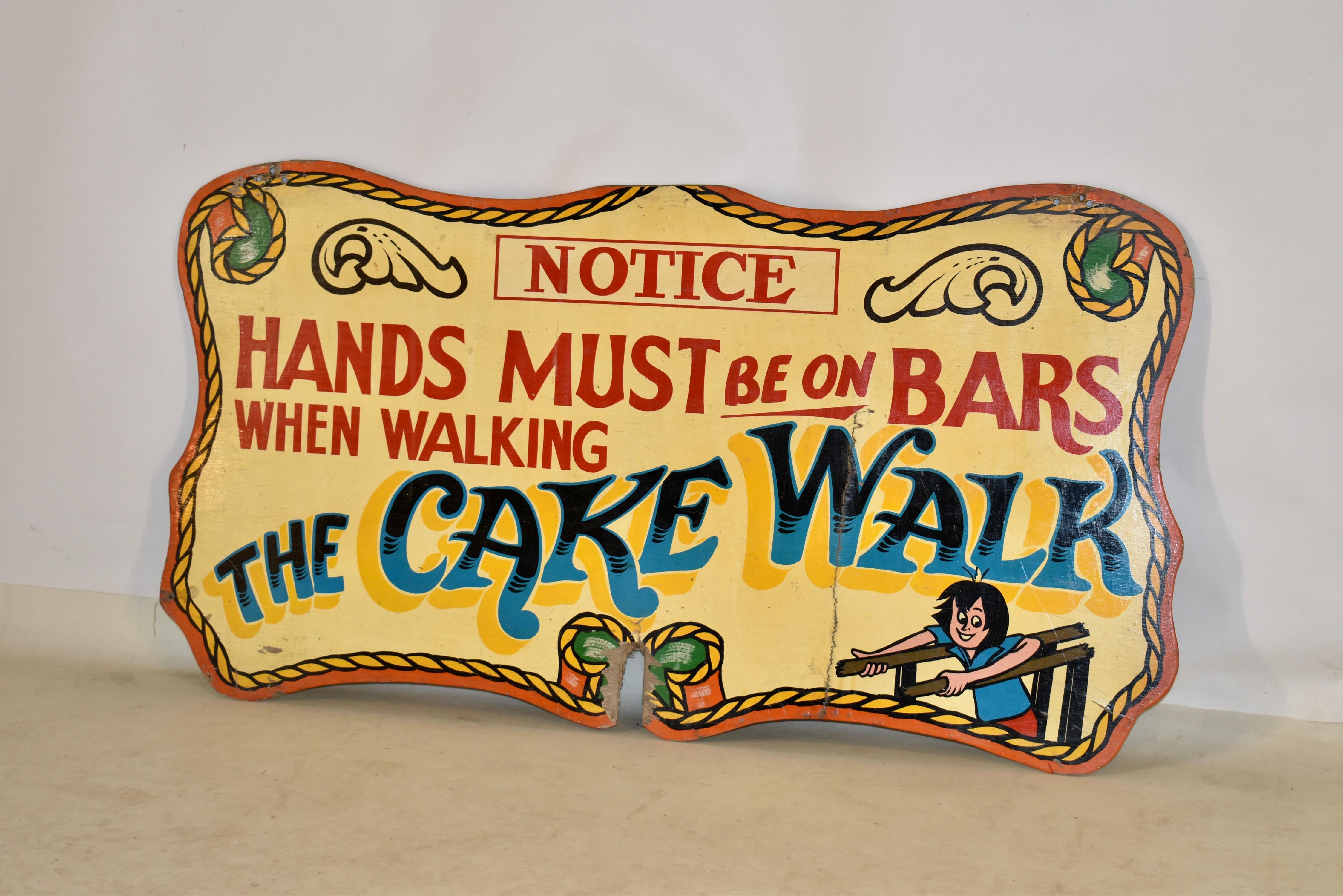 1960s carnival art sign from England. It is advertising a cake walk on one side of the sign, and on the back has a charming message 