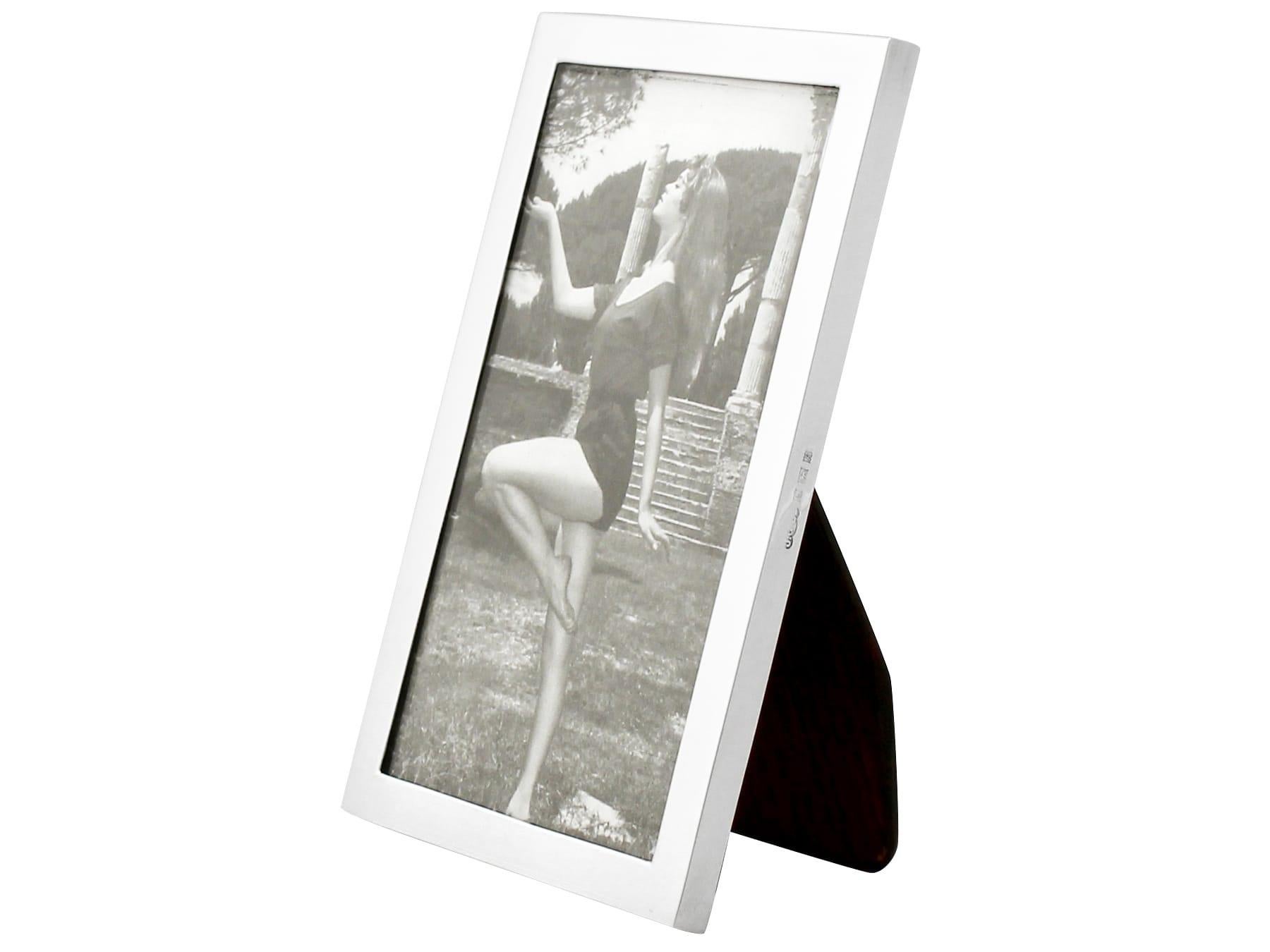 An exceptional, fine and impressive vintage Elizabeth II English sterling silver photograph frame; an addition to our ornamental silverware collection.

This exceptional vintage Elizabeth II sterling silver photo frame has a plain rectangular