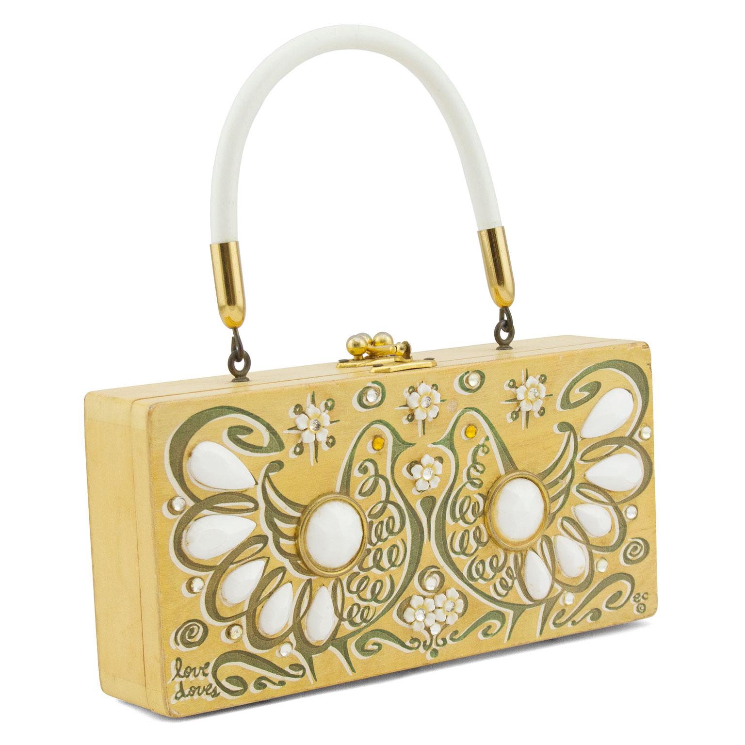1960's Enid Collin pine coloured wood rectangle box handbag. The bag features two hand painted doves facing each other with applied white beads, rhinestone and floral embellishment. White plastic hard handle. Gold tone hardware. Interior features a