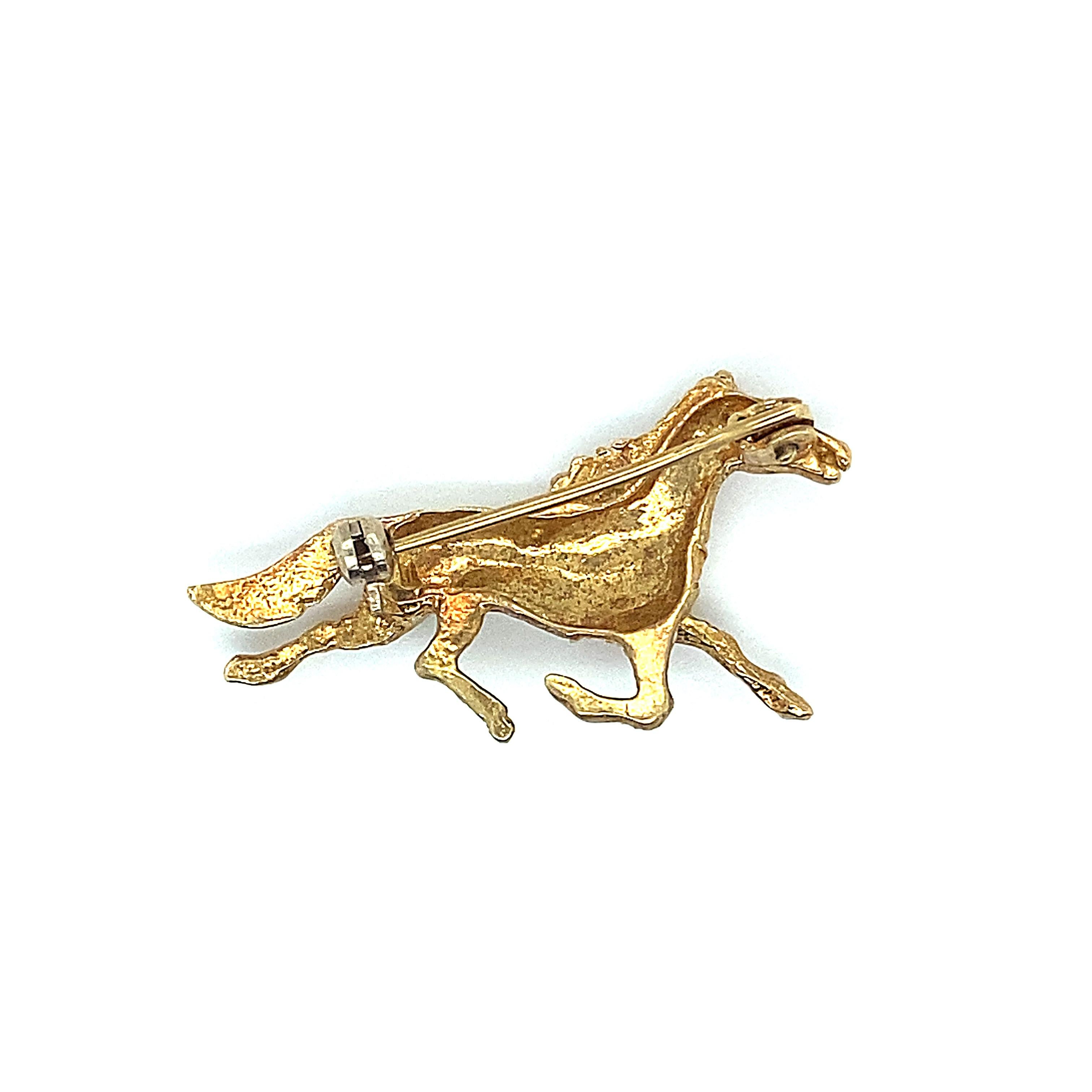 Item details:
Metal Type: 18 karat yellow gold
Weight: 5.9 grams
Measurement: 1.5 inches height x .25 inches width

Item Features:
1960s Equestrian Brooch crafted in 18 karat yellow gold with Intricate detailing using different textures of gold to