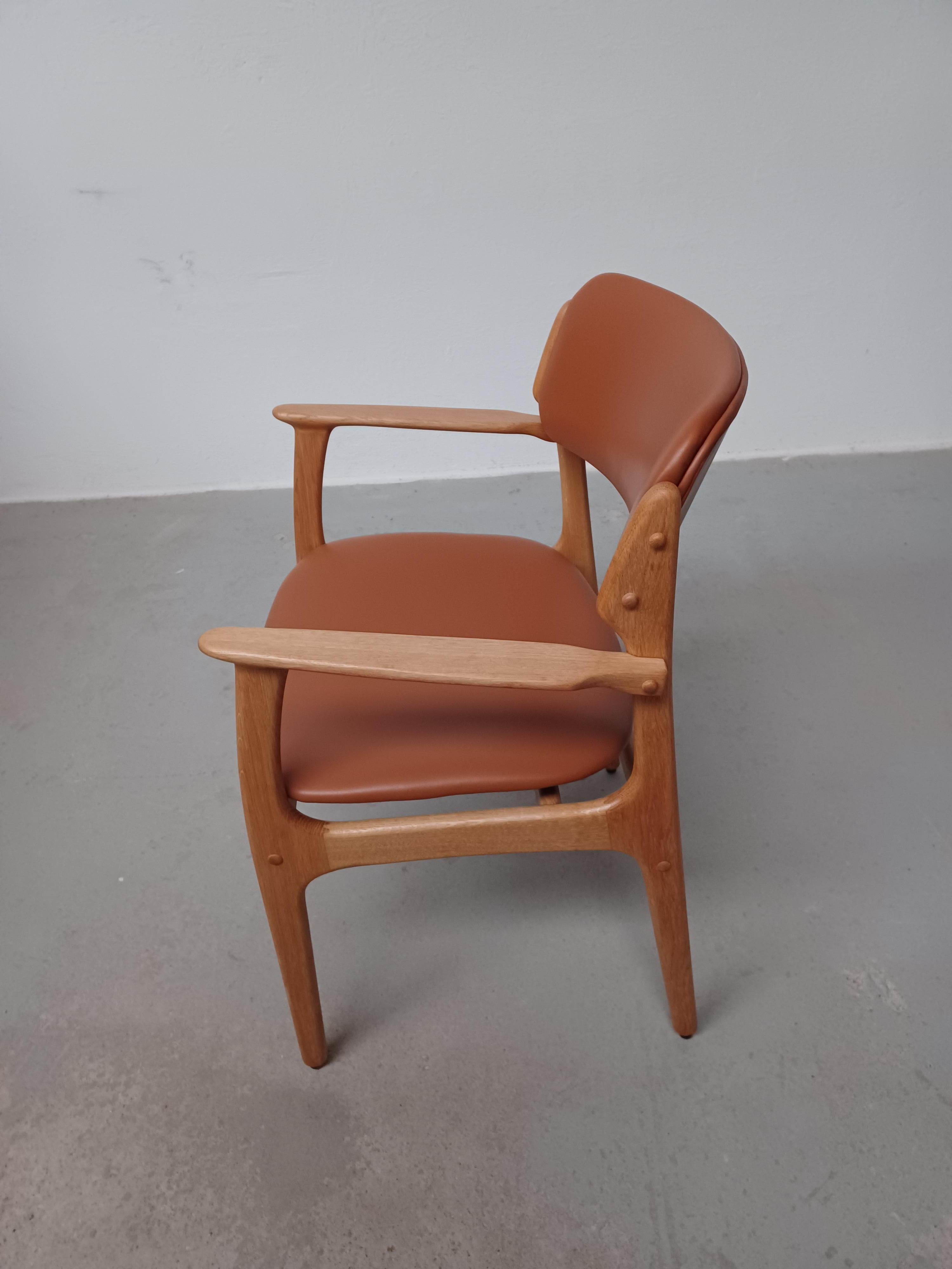Erik Buch set of two fully restored oak armchairs with excellent woodwork that are evidence of the supreme mid-century Danish design and craftsmanship.

The chairs feature a solid oak frame with Erik Buch's characteristic floating seat and rounded
