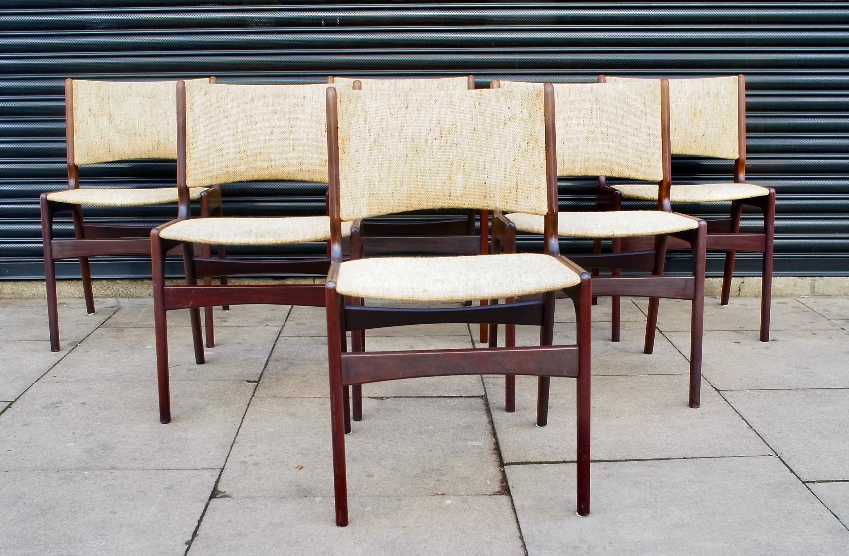 A stylish and rare set of six set of model 89, Danish solid teak framed dining chairs with original oatmeal coloured textile upholstery.  Designed by Erik Buch for povl Dinesen, these dining chairs feature a curved “floating” seat with a sculpted