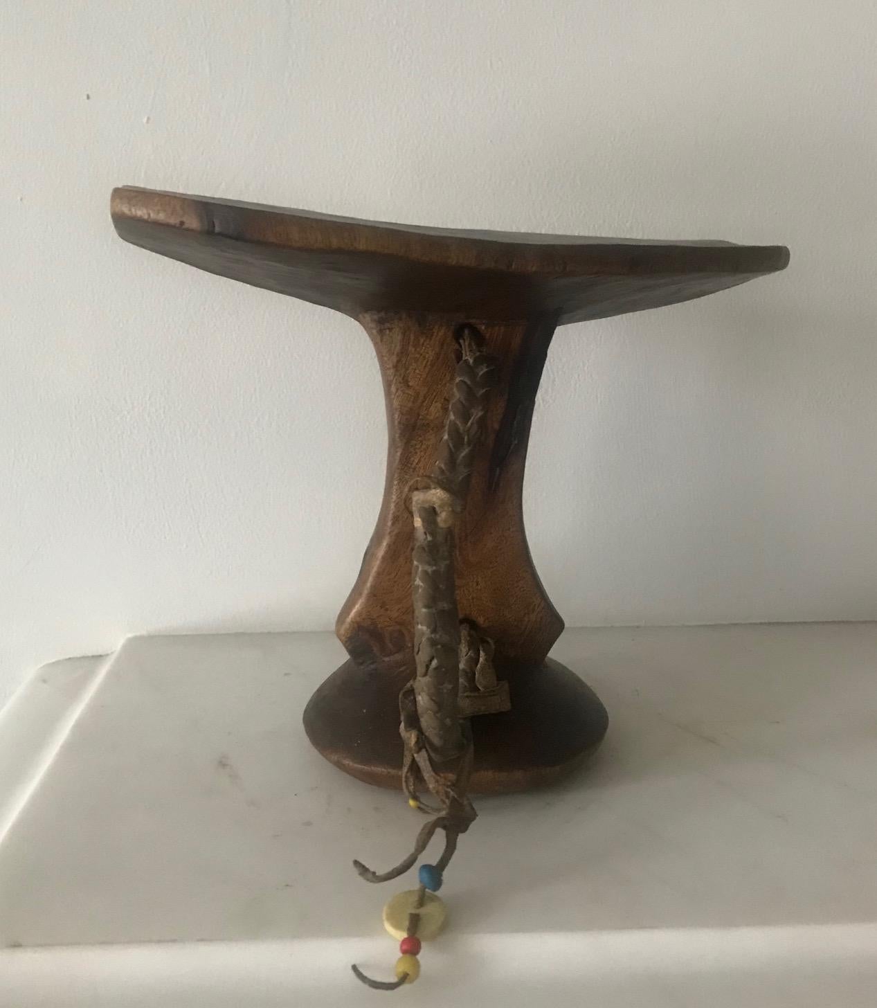 A lovely example of a 1960s Ethiopian headrest with original leather handle and beads.