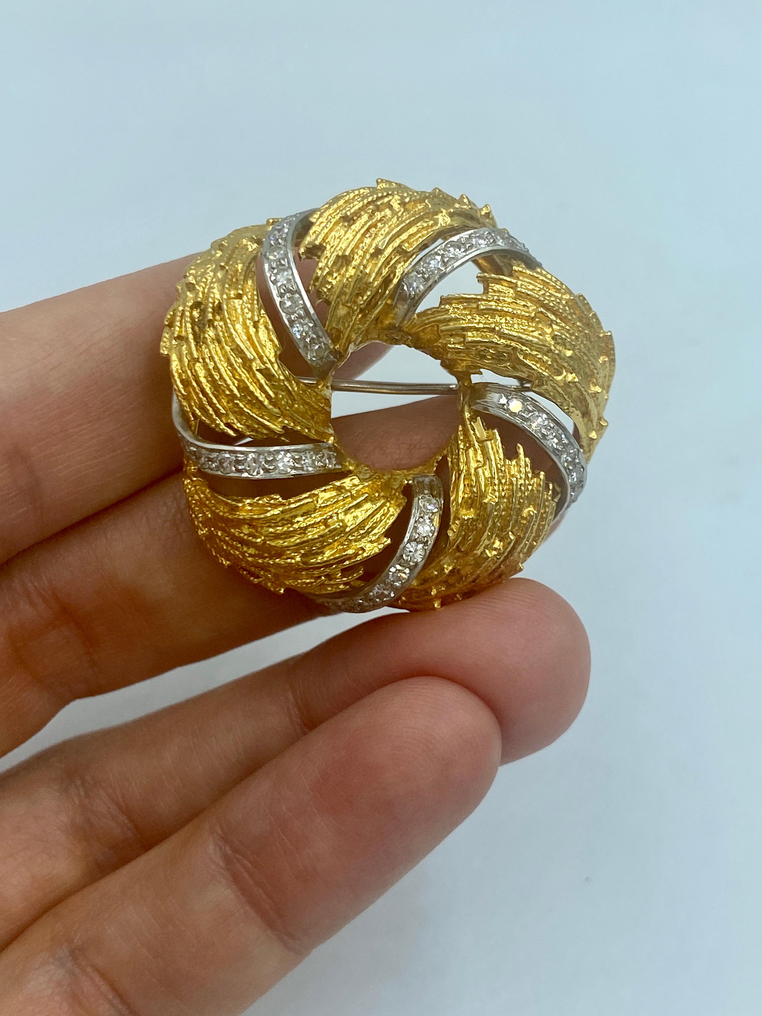 A charming 18k gold brooch made in Europe in 1960s in the shape of a wreath. It is the perfect size to pin on a lapel or collar, delicately adorned with approximately 0.5 carats of round cut diamonds.