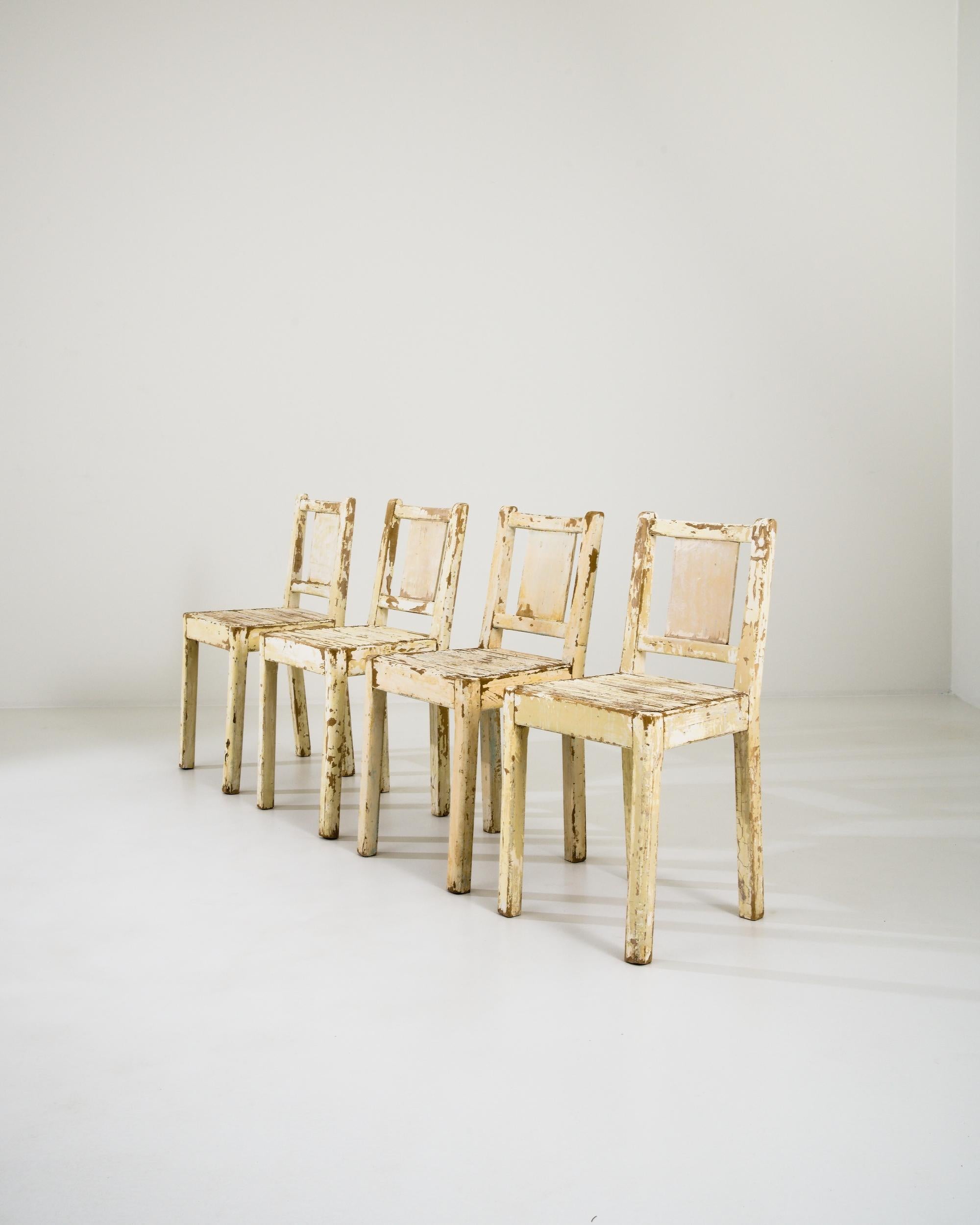 A set of wooden dining chairs from Europe circa 1960. Exuding a bright and sunny disposition, these chairs show off an array of yellows, beiges, and browns that have been collaged together on their surfaces over their long history and experience. As