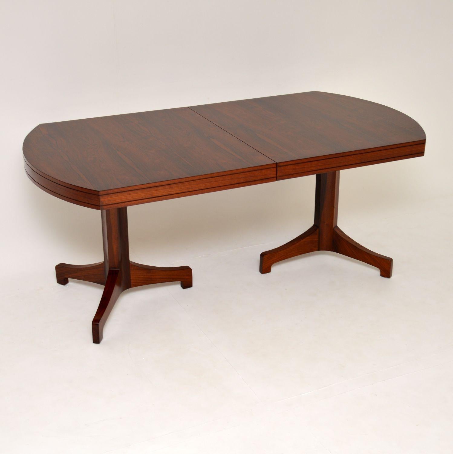 A stunning, exquisitely made and very rare vintage dining table. This was designed by Robert Heritage, it dates from the 1960s.
This is of the utmost quality, the wood grain patterns and color are absolutely stunning. There is an extra leaf that