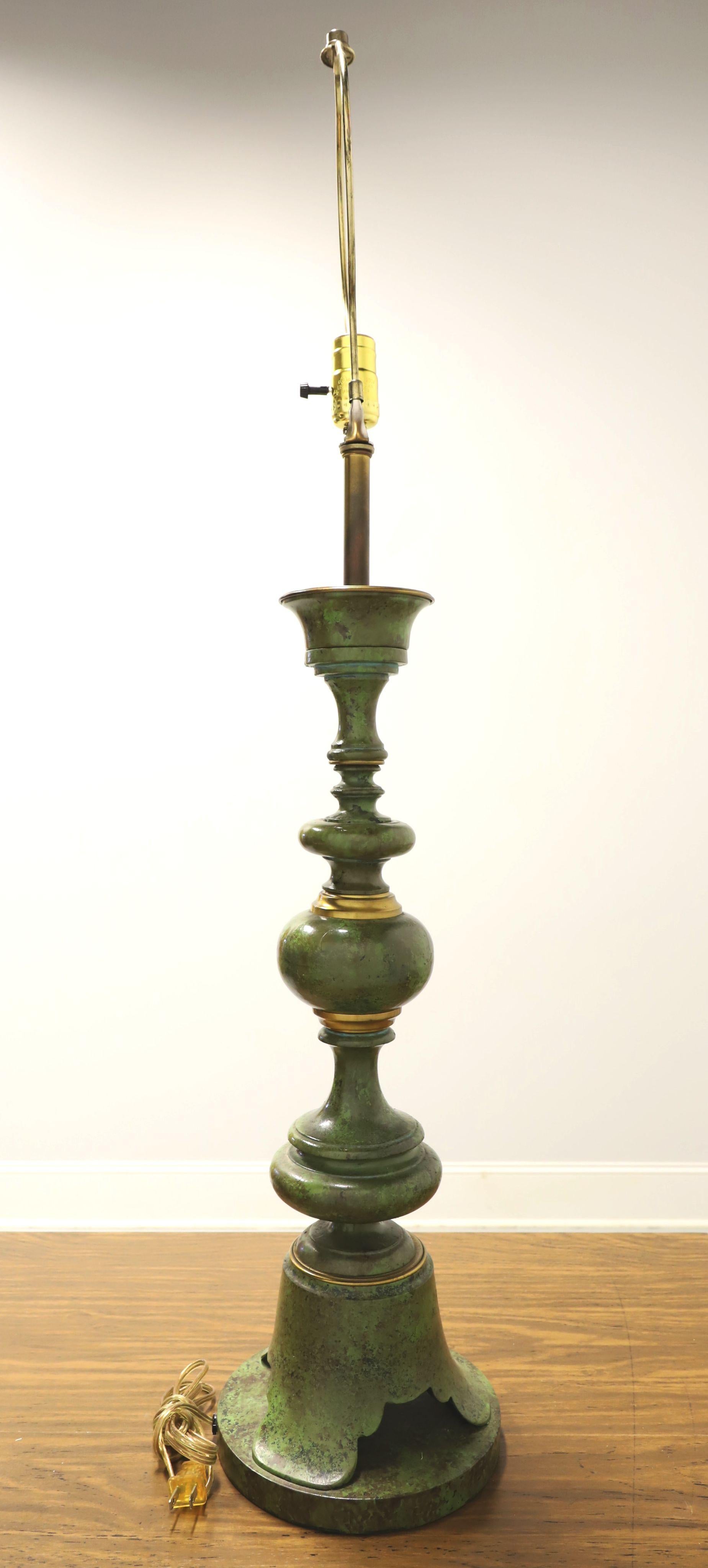 An extra large Hollywood Regency style table lamp, unbranded. Solid metal painted in a green and black marbleized design with gold ring accents and bell like base. Single standard bulb socket with on/off rotary switch, removable brass harp and brass