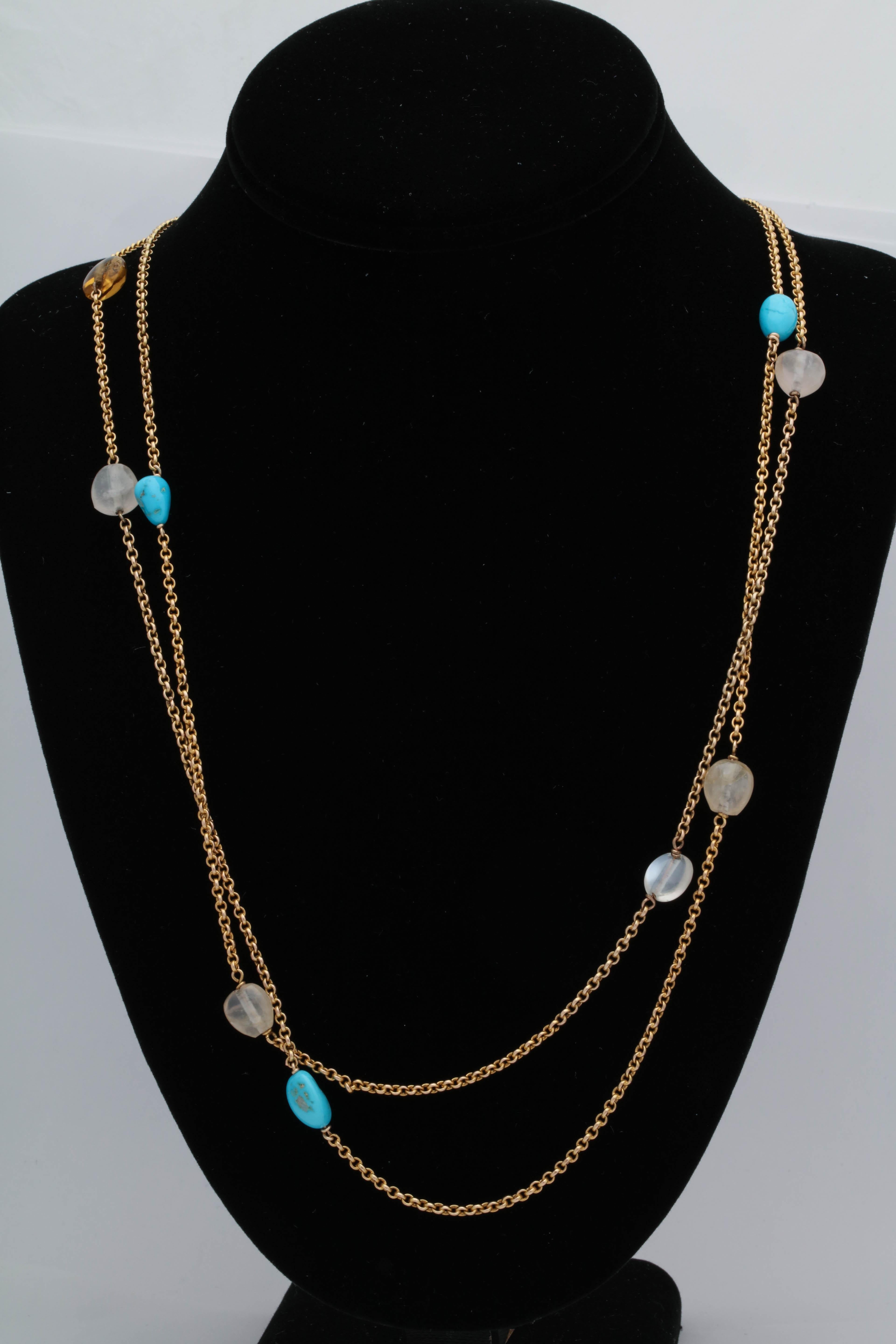 One Ladies 18kt Yellow Gold Box Link Chain Necklace Sporadically Embellished With Fourteen 8MM Semi Precious Stones. Stones Consist Of The Following :Three Turquoises, Two Amethysts,Four Moonstones ,Two Citrines,& Three White Quartz.All Stones Set