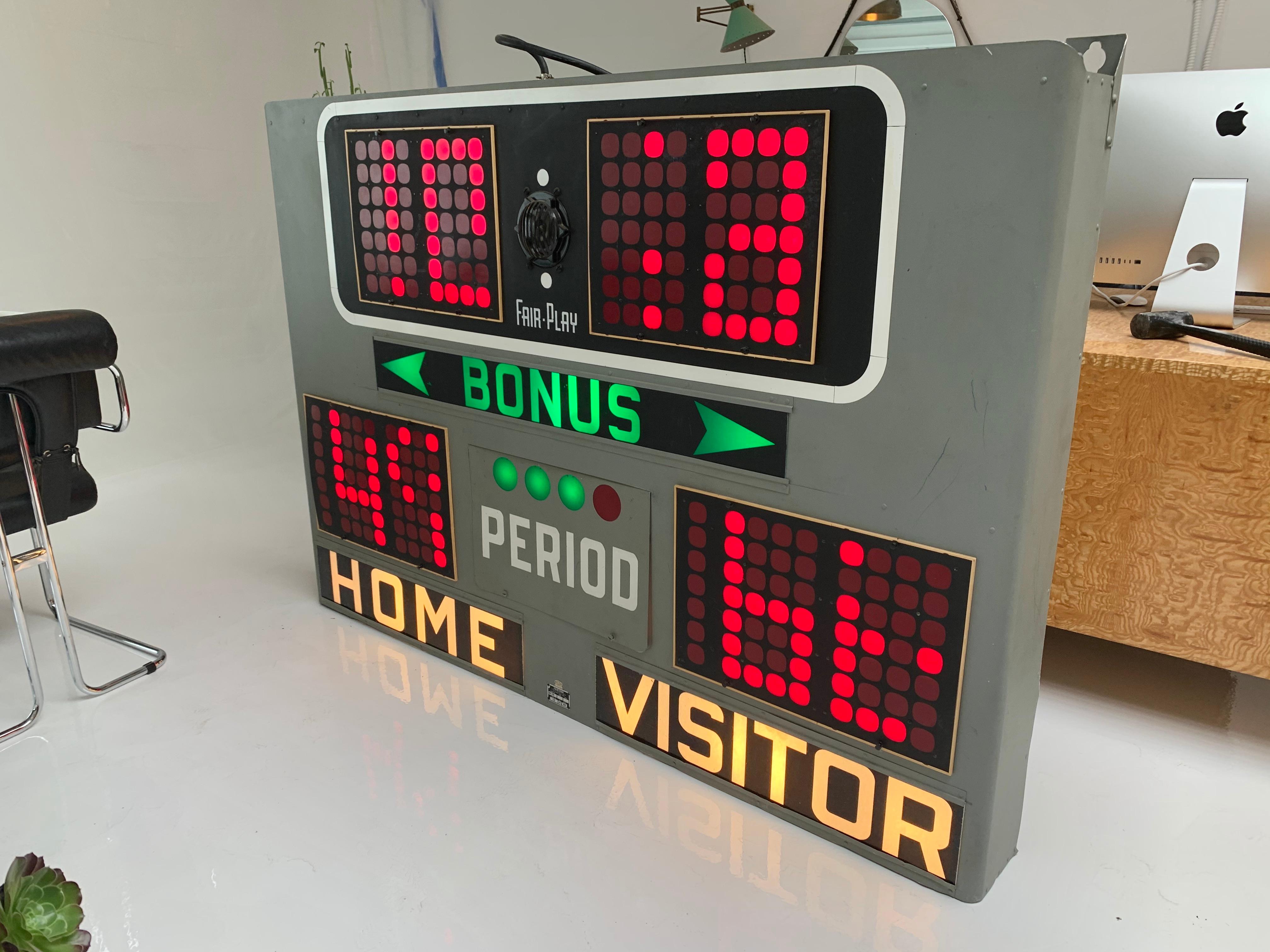 Fun vintage basketball scoreboard by Fair Play, made in the 1960s. Really cool grey metal frame with green, red and white coloring. In full working order, with timer, shot-clock, bonus section, score and working horn. Each movement of the board is