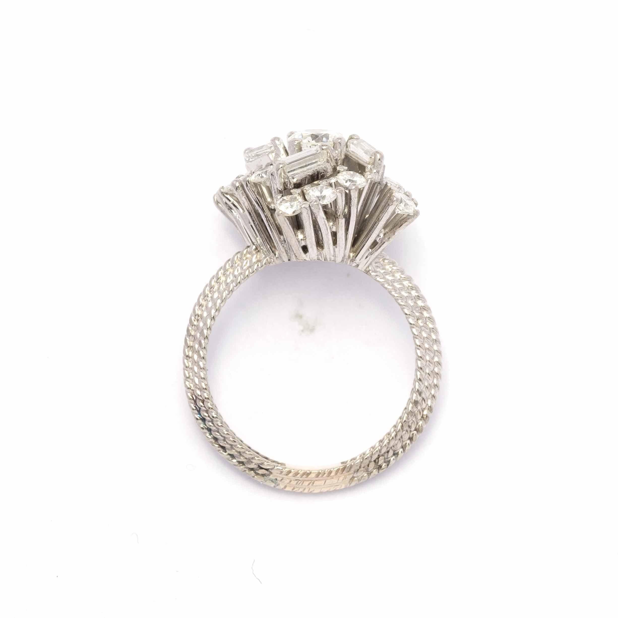 Unusual whirlwind design in this diamond ring set in 18ct gold from the 1960s period c.a. The diamonds are round and baguette cut for 1.70 ct total c.a.

Highlights:
- 18ct gold setting
- 1960s period c.a.
- Round cut diamonds for 1.20 ct total