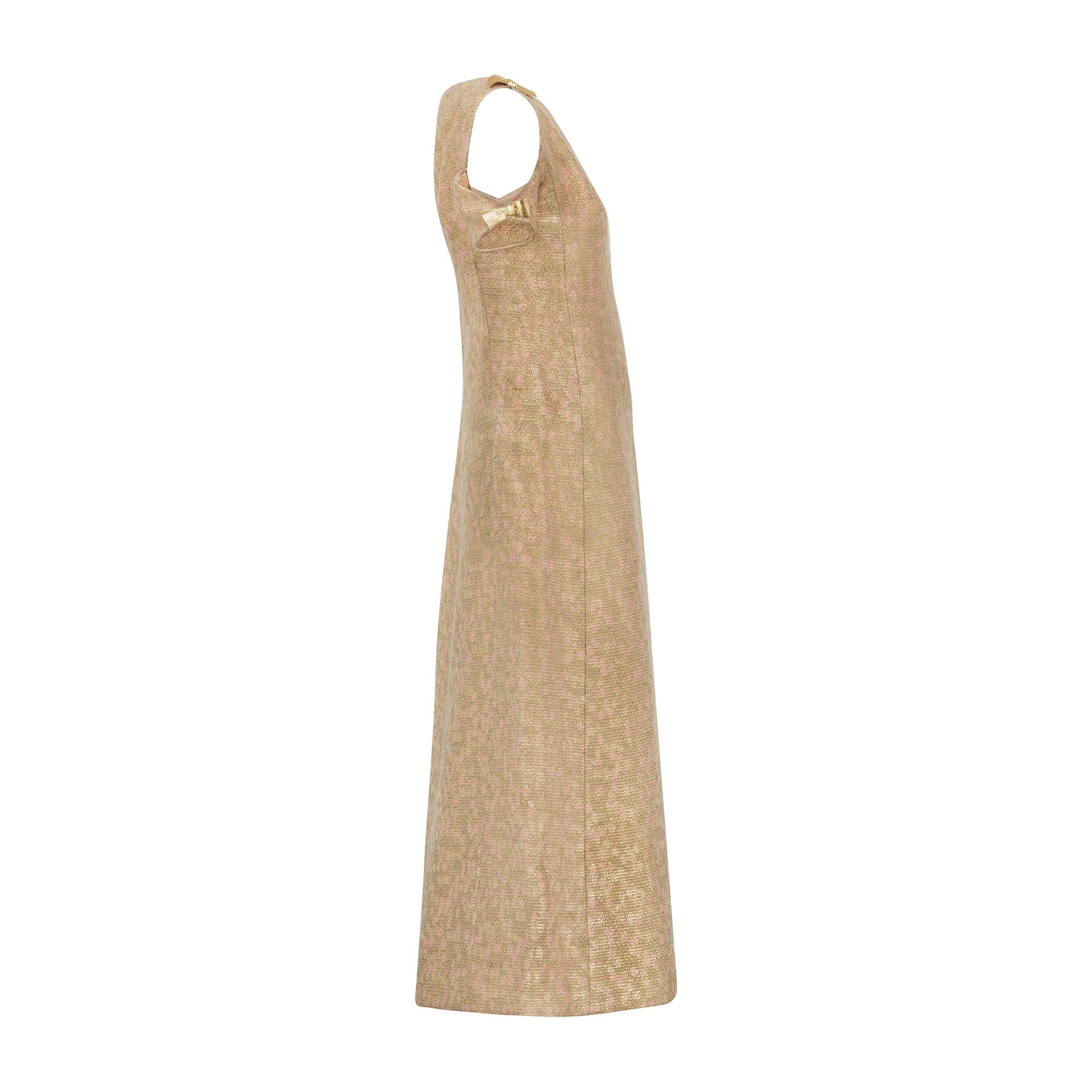 This elegant, fantasy tweed dress was couture-made in the 1960s. Fantasy tweed is a multi-colour tweed woven to a highly distinct pattern from clashing fibres of different fabrics. In the case of this stunning gown, the tweed has a background of