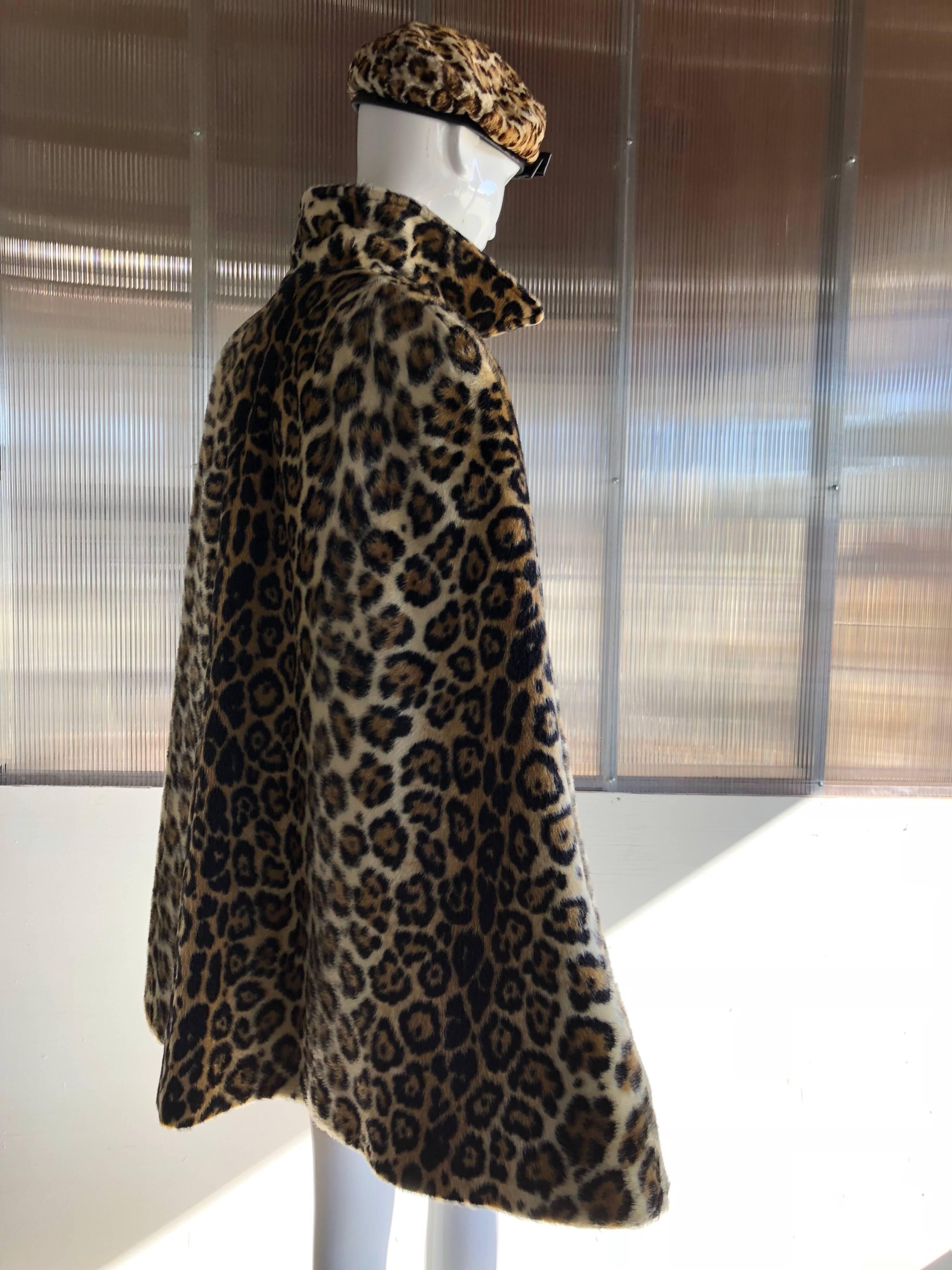 1960s faux fur leopard cape is completely reversible to a soft camel color wool . Wonderful slight swing construction and nicely tailored collar keeps this piece current in today's street style. Details include ; horn colored buttons up the front