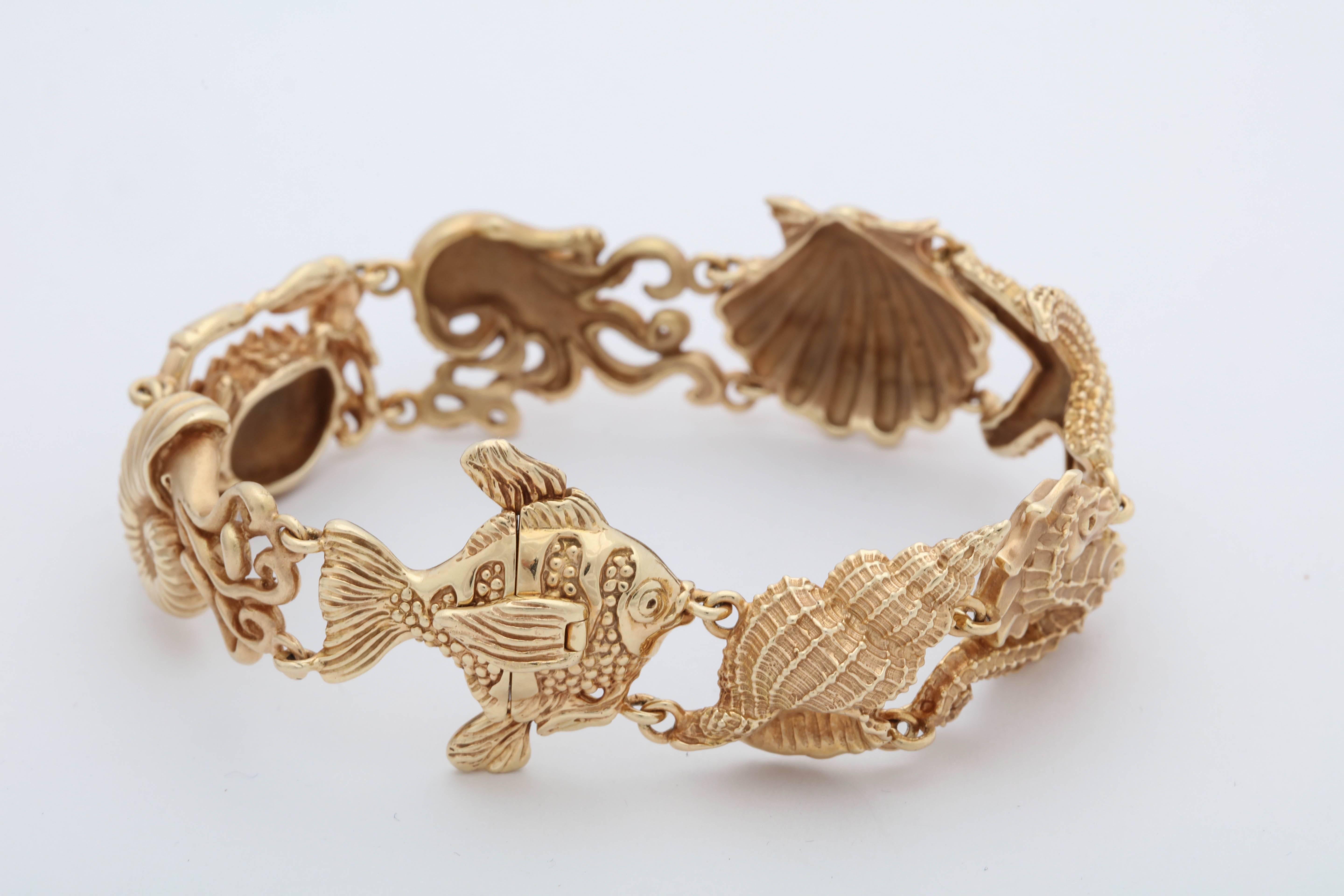 One Ladies Nautilus Figural Bracelet Composed Of One SeaShell,One Cornucopia, One Seahorse, One Octopus,And One Figural Crab With One Angel fish And One Starfish Motif . Created In 14kt Gold With A Beautiful Invisible Safety Clasp Mechanism Created