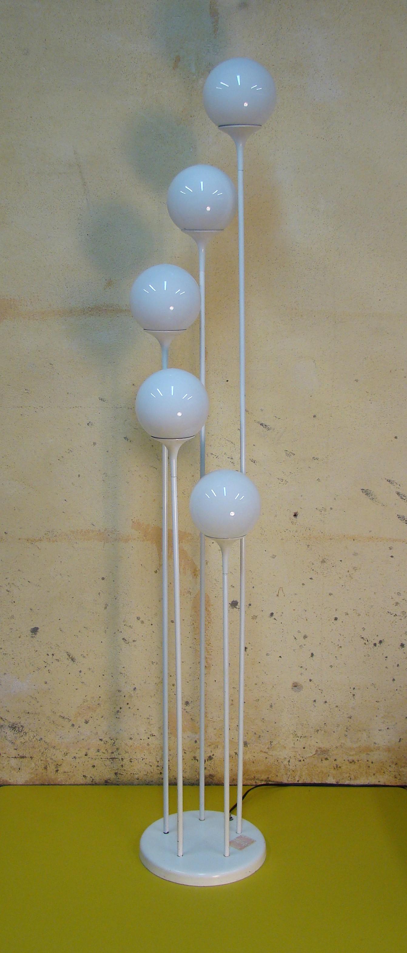 An uncommon white enameled floor lamp with five white glass globes on metal stems that mimic popular architectural themes of the period, namely Eero Saarinens 