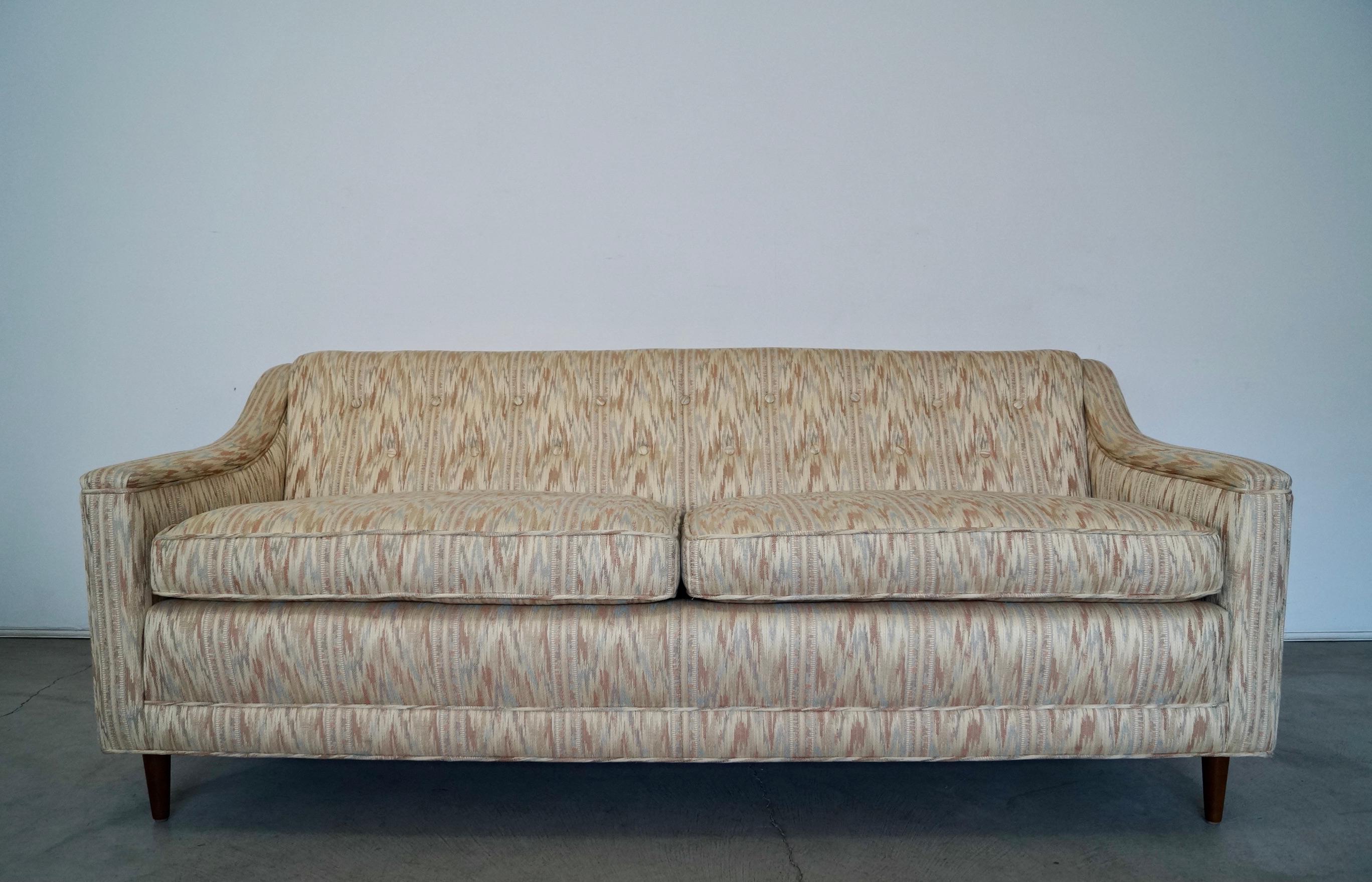 Vintage Mid-Century Modern couch for sale. It's from the 1960's, and is flawless. It's really solid and well made, and has coil springs on the seat frame and springs on the backrest. It has arms that slope, and a buttoned-back. It's really