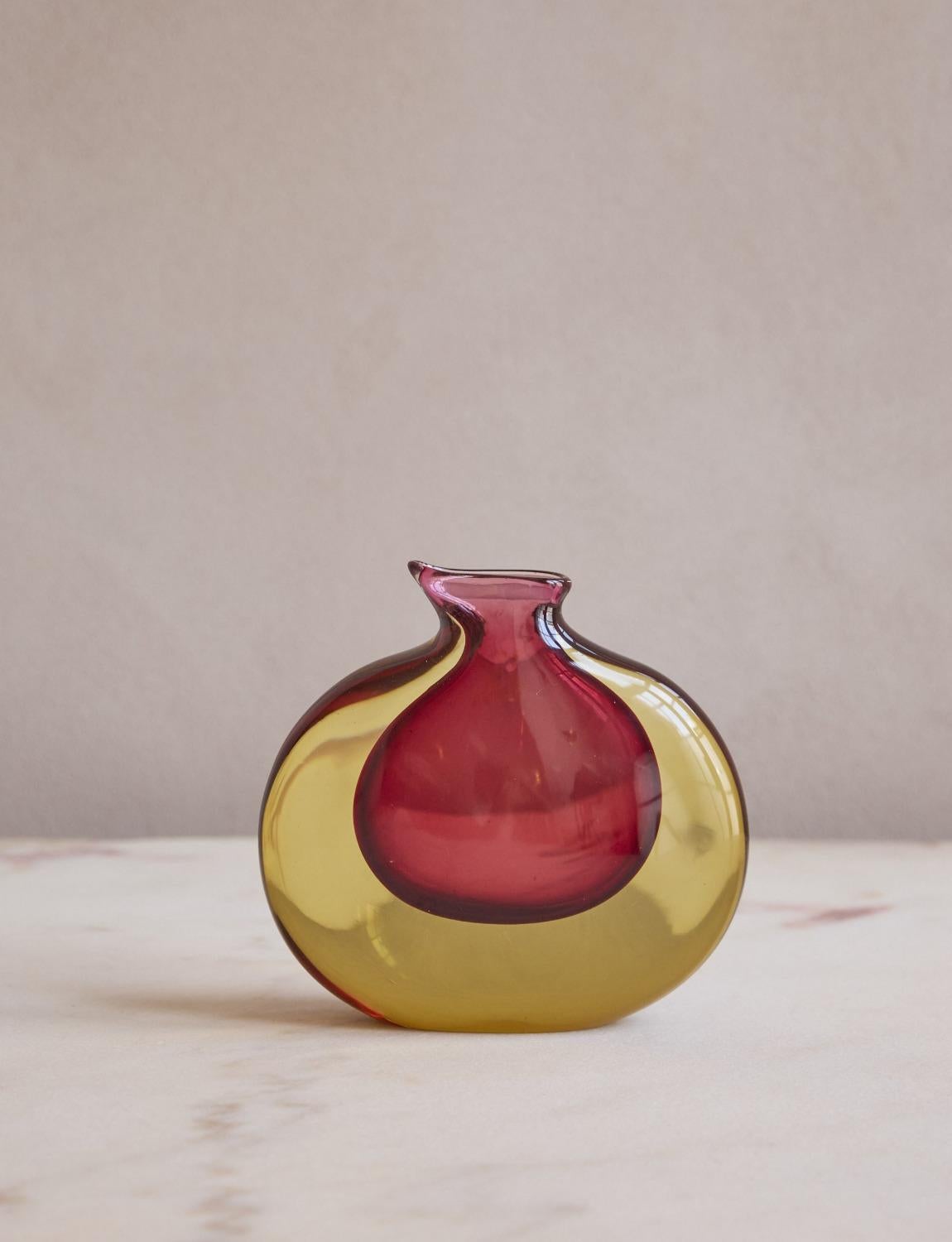 A wonderful example of a Flavio Poli sommerso vase. Hand-blown in the 1960s in Murano, this vase has a rich central red core with yellow surround. While petit in size, it makes a big impact due to its rich colours.